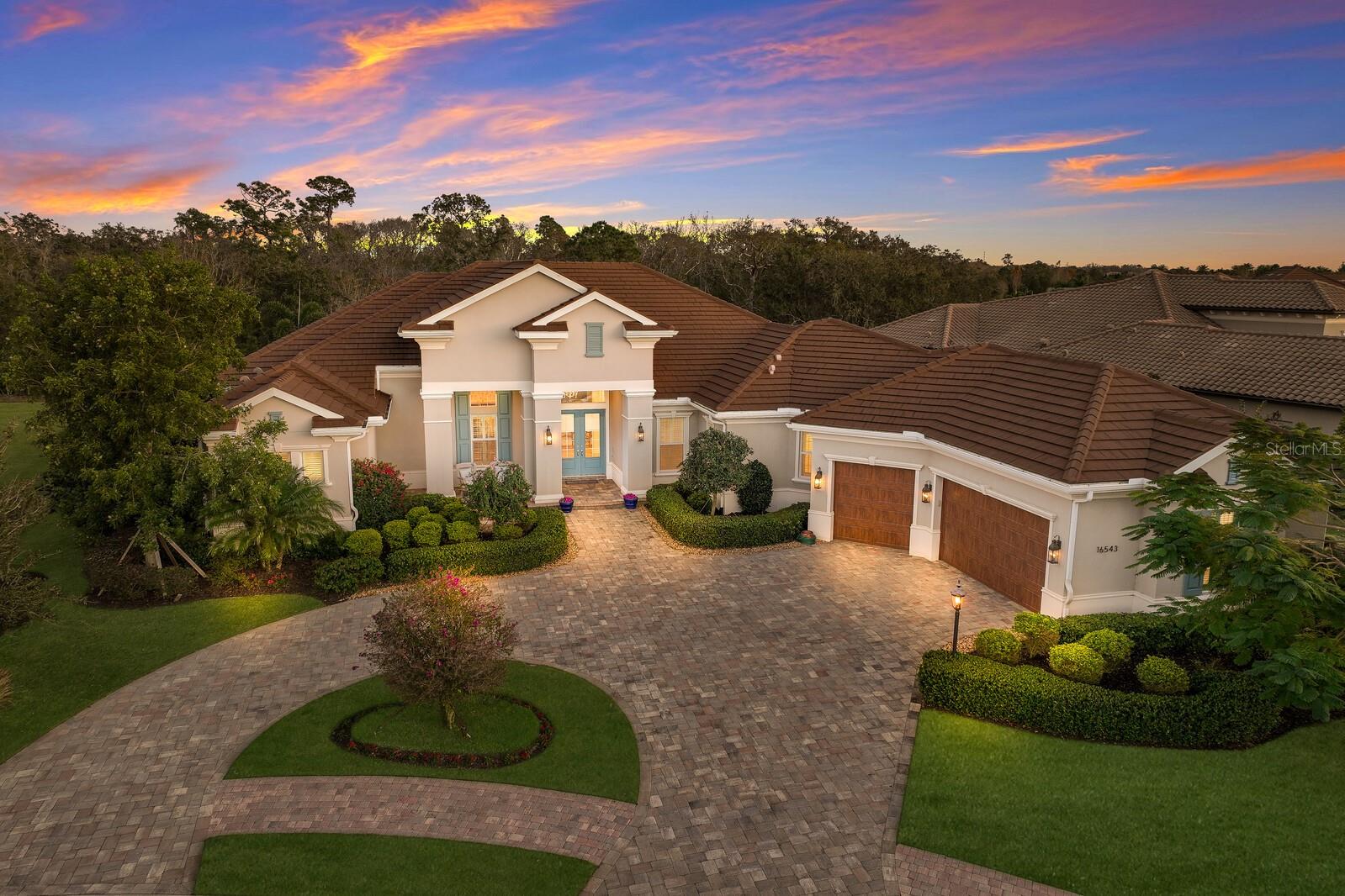 ACCEPTING BACK UP OFFERS! Welcome home to the prestigious gated community of Eaglescliffe in Lakewood Ranch Country Club East. This Lee Wetherington home is custom built on one of the finest preserve lots in the community. The nearly one-half acre lot sits back from the street providing a lovely first impression of your home as you pull into your circular drive and enter the oversized 3 car garage with additional space for a golf cart. The home boasts four bedrooms, four full baths, plus a bonus room. The 4th bedroom could also be used as an office or den. With 12-foot ceilings, hardwood floors, and handcrafted millwork, every space in this home was thoughtfully designed. The beauty of the finishes are magnified by the views of the whimsical wooded preserve from nearly every room. Disappearing sliding glass doors and seamless screens create the epitome of Florida indoor/outdoor living. Enjoy over 2,300 square feet of outdoor space for entertaining in your summer kitchen, with an alfresco natural gas grill with a vented hood, refrigerator, a natural gas firepit, and a gas-heated saltwater pool and spa. No detail was spared in the design of the chef's kitchen which includes a Sub-Zero refrigerator, Wolf gas range, Wolf microwave, Bosch dishwasher and an enclosed wine room with 116-bottle dual temperature-controlled wine refrigerators and wet bar. The primary suite exudes luxury with two walk-in closets, one of which is a 20-by-8 Hollywood closet with a built-in mini fridge and a TV hook up. The primary bath has a spacious walk-in shower with two rain heads and a gorgeous soaking tub. Other features include a separate 122 square-foot air-conditioned storage room, two zone A/C heat pump system with a WiFi thermostat, 400 amp electric service, pre-wired for an emergency generator, tankless instant hot water heater, water softener, a central vacuum, a whole-house security system and a Ring doorbell. This home sustained no damage from recent hurricanes. Country Club East, a private gated community, offers amenities including a fitness center, two clubhouses, and three community pools. Please note that the photos were taken when previous owners’ furniture was in place, beginning January 2025 there will be new furniture in place available for purchase on a separate bill of sale. Lakewood Ranch Golf and Country Club has four championship courses, two award-winning clubhouses, a 20-court tennis center, pickleball courts, two heated pools and a 24-hour fitness center.