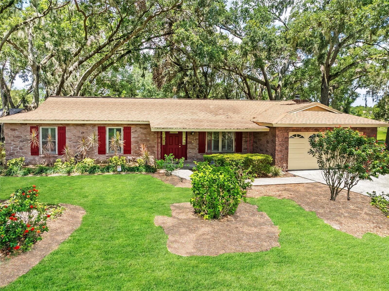 Welcome to this meticulously maintained 3-bedroom, 2-bathroom home situated on a stunning corner lot over ¼ acre in the established and sought-after neighborhood of Shanfri La. This inviting property offers a functional and versatile floor plan featuring two spacious living areas—ideal for both relaxation and entertaining.The galley style kitchen is both charming and efficient, boasting rich wood cabinetry, Corian countertops and plenty of storage. Engineered hardwood and tile flooring run throughout the home combines style with low-maintenance living. Step outside to a peaceful backyard oasis complete with mature landscaping and a large screened in porch - perfect for morning coffee or evening gatherings. The expansive backyard offers ample space for pets, gardening, or even a future pool. As a bonus, residents of Shangri La enjoy community access to a tranquil lake—perfect weekend activity. With an easy commute to both Tampa and Sarasota, this home offers the best of Florida living in a serene and well connected location. Don’t miss your chance to make it yours!
