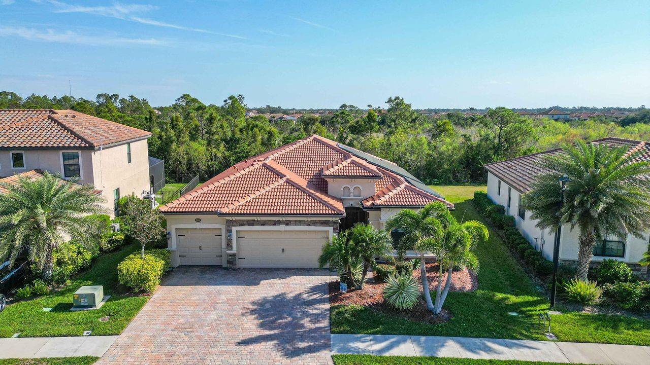 An UNMATCHED OPPORTUNITY awaits in the exclusive, gated community of GRAN PARADISO in WELLEN PARK, where this meticulously upgraded 4 BEDROOM, 2 BATH home redefines modern living. This SOLAR POWERED home is NOT IN A FLOOD ZONE. Offering an UNRIVALED COMBINATION of luxury, efficiency, and prime location, this home is truly in a class of its own—there is simply nothing else like it on the market. From the moment you arrive, the home’s striking curb appeal sets the tone, featuring a NEW TILE ROOF (2023), HURRICANE IMPACT WINDOWS, and an EXPANSIVE 3-CAR GARAGE with an OVERSIZED DRIVEWAY, perfect for extra parking or storage. Inside, NATURAL LIGHT floods the space, illuminating the PORCELAIN TILE FLOORS and creating a seamless flow between living areas. The GOURMET KITCHEN is designed for those who love to cook and entertain, boasting GRANITE COUNTERTOPS, UPGRADED APPLIANCES, including an INDUCTION RANGE & CONVECTION OVEN, and a WATER FILTRATION SYSTEM for pristine drinking water. Thoughtful details continue throughout with CUSTOM BUILT-IN CLOSETS, maximizing storage and organization in every room. What truly sets this home apart is its commitment to efficiency and innovation. BLAZING FAST INTERNET SPEEDS with 500mbps UP / 500mbps DOWN. PAID OFF SOLAR PANELS, TWO POWERWALL BATTERIES, an EV CHARGER, and an ENERGY-SAVING WATER HEATER not only reduce your carbon footprint but also dramatically lower energy costs. The UPGRADED HVAC SYSTEM with a UV AIR HANDLER LIGHT ensures fresh, clean air year-round. Step outside to your own private retreat—an EXTENDED LANAI overlooking a SERENE PRESERVE, where you can take in BREATHTAKING SUNSETS in complete tranquility. With no neighbors behind you, this ULTRA-PRIVATE LOCATION is the perfect escape. Living in GRAN PARADISO means more than just owning a home—it’s a LIFESTYLE UPGRADE. Enjoy RESORT-STYLE AMENITIES, including PICKLEBALL & TENNIS COURTS, a SPARKLING POOL & SPA, CLUBHOUSE, LIBRARY, PLAYGROUND, BILLIARDS, PING PONG, and a STATE-OF-THE-ART FITNESS CENTER complete with a SAUNA & STEAM ROOM. A dedicated LIFESTYLE DIRECTOR ensures an ever-changing calendar of events and activities. And let’s talk about LOCATION—this home is PERFECTLY POSITIONED just minutes from DOWNTOWN WELLEN PARK, THE ATLANTA BRAVES STADIUM, TOP-TIER RESTAURANTS, SHOPPING, FARMERS MARKETS, and MEDICAL FACILITIES. Plus, with 11 PRISTINE GULF BEACHES LESS THAN 20 MINUTES AWAY, your weekends will never be the same. With UNMATCHED VALUE, UNRIVALED UPGRADES, and an unbeatable lifestyle, this home is a RARE FIND. Furniture is optional, making it easy to move right in. Don’t miss your chance to experience THE BEST THAT GRAN PARADISO HAS TO OFFER—schedule your showing today!