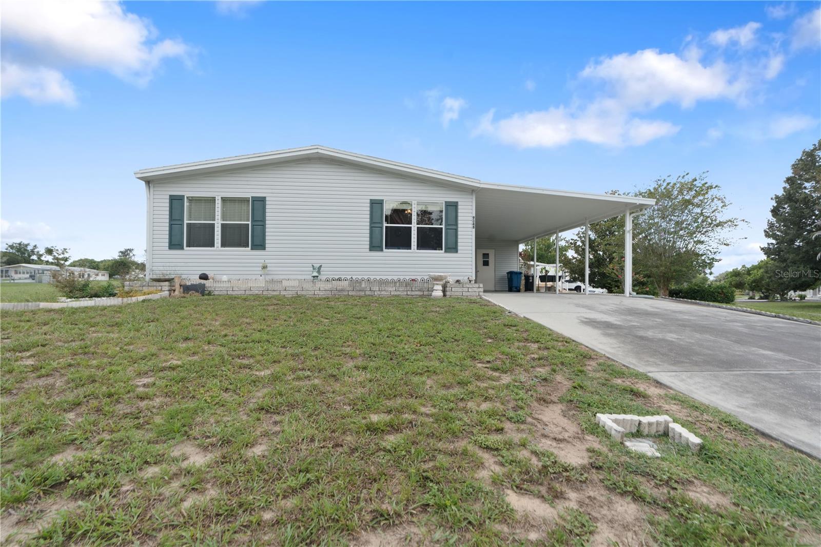 Wow. A spacious 1500+ square foot POOL home in the lovely golf course community of Brookridge (ages 55+) can be yours. The entrance is a manned gatehouse, providing you a nice level of security. This home is located 2.5 miles in the back of the community where there are newer homes. This 3 BR, 2BA home is a 1997 Fleetwood model, manufactured doublewide home. You own the lot (plus additional 1/2 lot) it sits on where you can enjoy the Magnolia tree and Crape Myrtles. The HOA is $75 monthly and includes all the amenities and planned activities. The SALT WATER pool is large- 14 ft x 28 ft, was recently re-marcited, has paver decking and is fully bird-cage enclosed. There is a covered outdoor area for entertaining poolside. The electricity in the house plus the pool run on solar (7 panels) and they are completely paid for. Average electric bill is $30 (highest was $120)The roof and A/C were replaced in 2013 and the hot water heater is original to the home. This home has some additional desirable features you are sure to love: SKY Lights in bathroom and kitchen add brightness and natural light! The architecture is unique - Built-ins around the living room windows, high cathedral ceilings and vaulted in the kitchen. There is so much storage space! The closet in the primary bedroom is so large that owners use it as an office and craft supply space! The primary bathroom has an additional door that leads directly to the pool. The shed has full electricity and a/c and would make another great work space, sewing room, etc. Sellers have lived here long and it is time to downsize. They say the neighbors are the truly the best - very kind and everyone looks out for each other. It's the kind of community anyone would love. Furniture and contents come with the house, minus several items and personal possessions the owners will indicate. This is a must see home that offers so much for the new buyer. Don't delay. Schedule to see it today! Silk curtains do not convey.