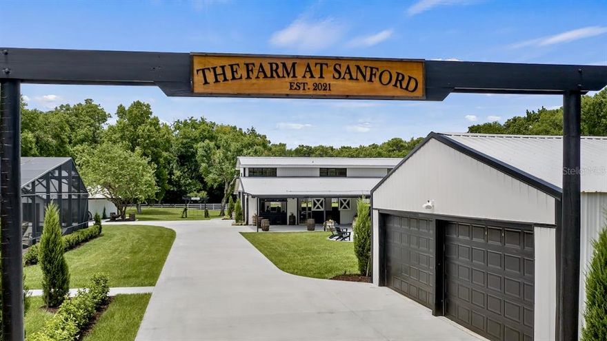 The Farm at Sanford is a ‘one-of-a-kind’ property covering almost 14-acres near the St. Johns River in Seminole County. The grand scale of the property is apparent upon entering the compound, yet once inside, there is a sense of peace and tranquility brought on by the sheer magnitude of the space, the meticulously manicured grounds, mature oak trees, two fire pits with ample seating, sparkling ponds with fountains and perimeter fencing. 

The sprawling 3000+ square foot Farmhouse has a rustic, yet sophisticated feeling with three bedrooms, 2 bathrooms and spacious living areas. The chef’s kitchen features high end stainless steel appliances that will inspire fabulous meals in the formal dining room. The family room enfolds to the bonus room and out to the oversized lanai with outdoor lounging area. The screened sparkling pool features ample area for catching the rays or relaxing in the shade - enjoy a permanent “staycation” at the farm. The opportunities are endless. The main home includes an attached 2 car garage and sprawling front porch that makes you feel at home.


The 1000+ square foot Guest House features a spacious open floor plan with full kitchen, two bedrooms and 2 bathrooms. There are two separate oversized 1 car garage bays, one includes a washer/dryer and comes complete with a catering prep area. The guest house structure includes a bonus/game room and separate access to his and her restrooms for events.


The showcase of the farm is the elegant 3600 square foot barn with large attached undercover patio that his been transformed into the perfect place to host events or continue to develop a burgeoning destination wedding business. The vintage Ford truck shown in the photos and video conveys with the property along with the tractor. The barn includes all of the furnishings, cabana bar and hi-tech audio video system.  Adjacent to the barn is another oversized storage garage for farm toys and storage. 

Additional property features include: in-ground trampoline, tree swings, paver areas for entertaining/dancing, parking area with lighting, irrigation well and acres of pasture. The Farm is less than 30 minutes to Downtown Orlando and 45 minutes from the beaches.