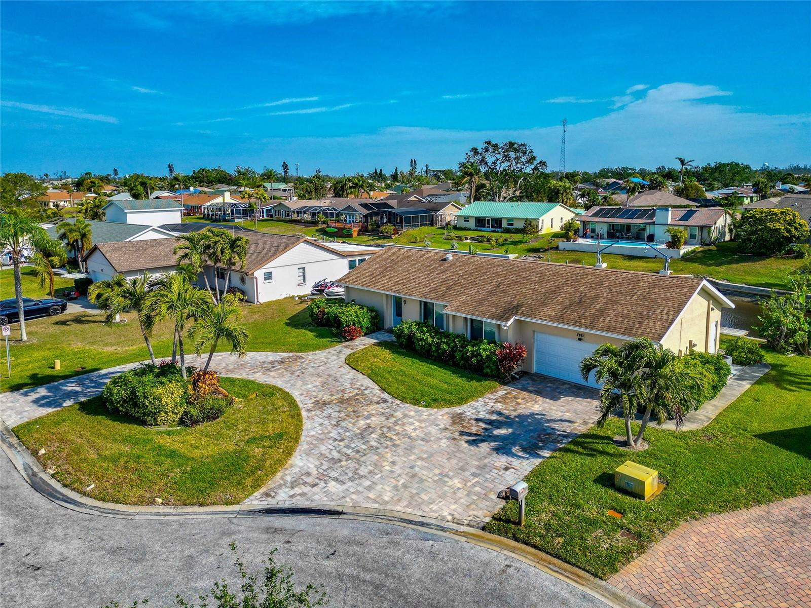 Attention, boating enthusiasts! Imagine stepping out your back door, hopping onto your boat, and setting sail for the Gulf within minutes—no hassle, no waiting, just pure waterfront living. And the best part? You can make this dream a reality for under $650K. Don’t miss the chance to indulge in the ultimate lifestyle—your adventure starts here! So much to LOVE about this home: Boating, Canal, Dock, Waterfront, Minutes to Beaches, New Paver Circular Driveway, Newer Windows, New Impact Front Door, New Flooring, Lg Fl Room, 2 Car Garage. Experience the ultimate in waterfront living with this exceptional opportunity to own a private boat dock on a freshwater canal, offering direct access to the bay and Gulf. Imagine enjoying stunning sunsets, playful dolphins, and graceful manatees just minutes from home. Nestled in the sought-after Coral Shores East community on a private cul-de-sac, this beautifully updated coastal-style home seamlessly combines charm and modern conveniences. Even with your own private dock and unbeatable access to waterways, this house stands HIGH & DRY - NO FLOODING even through the recent storms. From the moment you arrive, the home's curb appeal captivates with its newly installed paver circular driveway and brand-new gorgeous impact front door. Inside, the light and bright open floor plan welcomes you with a warm and inviting ambiance. The spacious 31-foot Florida room, recently recarpeted, offers a tranquil retreat with breathtaking canal views. The enlarged primary suite is a true haven, featuring a large walk-in closet, freshly updated carpeting, and a private bathroom with a tiled shower. The galley kitchen boasts stainless steel appliances and picturesque water views, making it a delightful space to prepare meals. A split-bedroom layout ensures privacy, making this home ideal for families or those working remotely. Step outside to your backyard dock and immerse yourself in the serenity of pristine water views, perfect for relaxing or entertaining. The two-car garage offers ample space and includes a dedicated work or storage area, with an upgraded garage door system and ceiling storage racks. Additional enhancements include updated windows, new carpeting, fresh sod, and a beautifully designed paver driveway. Located just minutes from the beaches of Anna Maria Island, this home provides easy access to Sarasota Airport, IMG Academy, and a variety of shopping, dining, and entertainment options. This is your chance to embrace the Florida lifestyle—schedule your private tour today and make this waterfront oasis your new home.