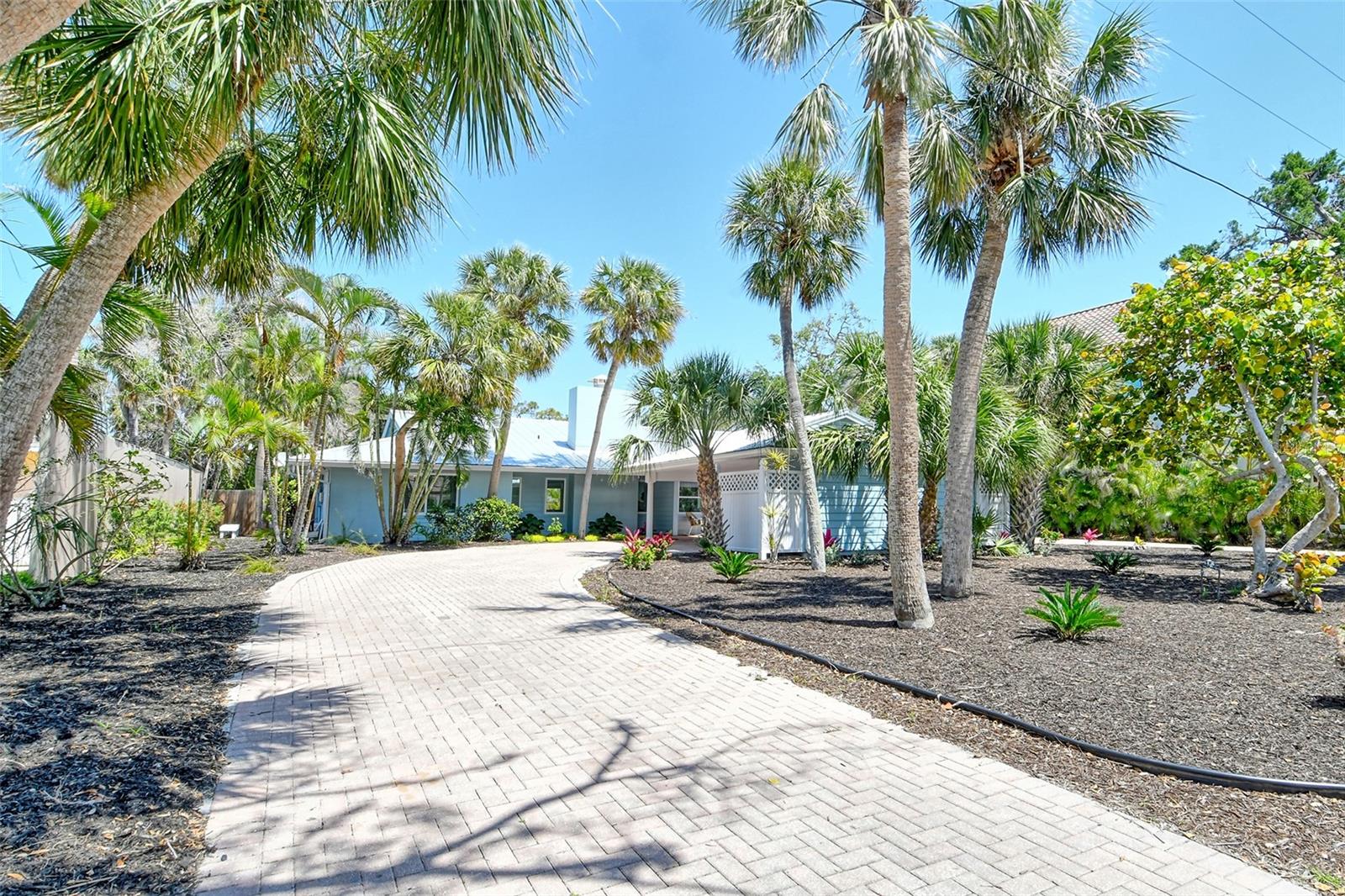 SIESTA KEY, Sarasota, Single Family Pool Home….Well-positioned for convenience and natural attractions . . . and dinners are breezy on your patio! The advantages of this appealing home in the Siesta area of Siesta Key become apparent while you are still walking the perimeter. The clear blue pool and the patio are a perfect pairing of amenities, supporting a variety of social activities and relaxation. Rear fencing of the carefully landscaped yard adds a privacy element to the enjoyment of these features.
Moving from the yard to the indoors, the charm of this home only deepens. The impressive entryway ushers you into an atmosphere of stylish lighting, sunlight, neutral colors, open floor plan, and a fireplace in the living room.
In the updated kitchen, which brims with stylish functionality, culinary endeavors are a pleasure! The kitchen connects seamlessly onto the living room, patio, and backyard. The scene is brightened by natural light. Culinary endeavors are powered by premium appliances.
The ensuite primary bedroom, conveniently located on the main-floor, is well-designed and luxurious. In addition to the convenience of the private bathroom and you will find ample closet space to let your wardrobe breathe. Offering uniqueness, respite, ensuite convenience, ample closet space, and conveniently located on the ground floor, the remaining bedrooms are ready for someone to make them their own.
Close to the natural beauty of Siesta Key Beach, you'll spend more time at destinations (or at home) than in transit.
After your local excursions, you'll return to the familiar welcome of traditional design, in a popular neighborhood where the low-traffic streets are framed by greenery. Call Today! Available May through September.