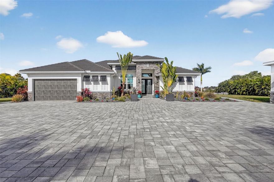 List price is starting price. Custom built in 2019, this exceptional home sits on 2.37 fully fenced acres offering privacy, mature palms, and open space, conveniently located near I-75, and Punta Gorda. The residence offers 2,882 sq ft under air with an open concept design featuring a spacious kitchen with quartz countertops, soft close cabinetry, upgraded appliances, tray ceilings, and recessed lighting, flowing into the living area with an electric fireplace.

The flexible floor plan includes a media room/playroom, dedicated office, and utility room with sink. The primary suite features tray ceilings, dual walk in closets, and a spa style bath with double vanities, quartz counters, soaking tub, and dual entry walk in shower. Generously sized secondary bedrooms are complemented by a pool bath with walk in shower.

Outdoor living is ideal for entertaining with a 30’ x 12’ covered patio, built in bar and TV, ceiling fans, and indoor/outdoor speaker system. The saltwater pool and spa include upgraded lighting, automation, and a clear view screen enclosure.

Additional highlights include impact windows, concrete tile roof, 3-zone A/C, spray foam insulation (home & detached garage), city water with septic, well for irrigation, 21 zone irrigation system, powered courtyard, detached electric garage, upgraded lighting, pavers, and fixtures. A rare opportunity to enjoy acreage, privacy, and versatility with modern convenience.