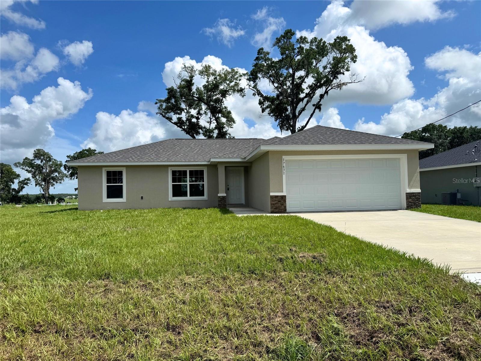 One or more photo(s) has been virtually staged. MOVE IN READY!! Newly paved roads and improved community! Beautiful new construction home! Luxury Plank Vinyl flooring throughout all living and common areas, tile in bathrooms, and carpet in the bedrooms. 3 bedroom, 2 bath, open floor plan with dining area and eat-in kitchen, all done in neutral, pleasing colors. Inside laundry with W & D hook-ups. Walk-in closet in Master bedroom. Stainless steel appliance package in the kitchen. Cabinets are white shaker-style with light luxury granite countertops. Please see attached documents from Builder (Builders Contract Addendum & Warranty) Actual photos of house plus virtually staged model home photos for reference. Any photos depicted are for illustration purposes only and only to show layout. Floor plan displayed is our standard plan and garage orientation may vary on actual home. Interior and exterior colors, finishes, and garage orientation will vary for actual home. Information is deemed correct, but no guarantee made. Any dimensions listed are approximate. Dunnellon Oaks Neighborhood received approval for MSTU to pave the roads in the subdivision. Road work HAS begun. Road Construction throughout the neighborhood will be ongoing until the expected completion August 2025. See attached Disclosure.
