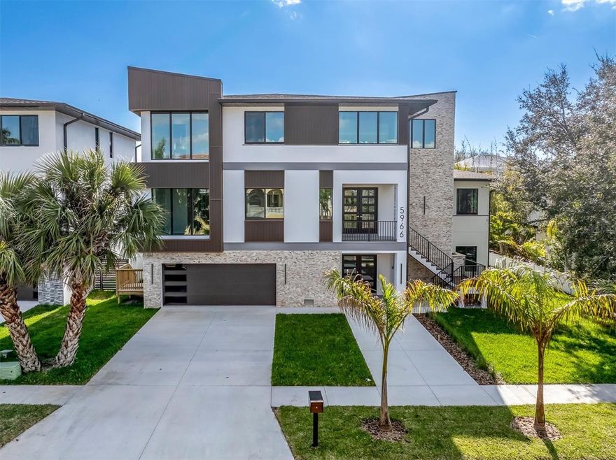 One or more photo(s) has been virtually staged. Under Construction. Experience modern coastal luxury in this newly constructed Pasadena Model Home, where striking contemporary architecture meets timeless Florida charm. Designed with clean lines and sunlit open spaces in cool gray tones, this residence blends style and function with effortless grace. Set within the exclusive gated Pasadena Yacht & Country Club community, this Skimmer Point masterpiece features a sparkling private pool and an impressive 4-car garage—perfect for those who value both elegance and practicality. Inside, sophisticated finishes, soaring ceilings, and seamless indoor-outdoor living spaces invite relaxation and entertaining alike. Residents have available the ability to join with a shorten wait time, the premier Pasadenta Yacht & CC with amenities including a private Arnold Palmer–designed golf course, full-service clubhouse, fine dining, tennis and pickleball courts, and an 80-slip marina accommodating yachts up to 80 feet. Just beyond the gates, discover the charm of downtown Gulfport—a short stroll away—offering boutique shopping, waterfront cafés, lively restaurants, and vibrant local markets. Including the luxury of Downtown St Petersburg, the beaches and Tampa, all of which just minutes away! This home is not just a residence—it’s a lifestyle defined by coastal sophistication and resort-style comfort.