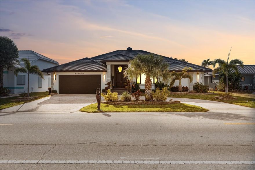 Perfectly positioned on a wide canal in the sought-after community of Punta Gorda Isles, this impressive custom waterfront home offers breathtaking long canal views and direct boating access to Charlotte Harbor and the Gulf of America. While the outside has been completely updated the inside is ready for you to design according to your preferences. Featuring 3 bedrooms, 2.5 bathrooms, and an attached 2-car garage, the light-filled interior showcases a spacious split-bedroom floor plan with a Great Room, Dining Room, Family Room, well-appointed kitchen with white cabinetry, solid surface counters, stainless appliances, and a cozy dining area. The large primary suite offers generous space and a private bath, while guest bedrooms provide flexibility for family or visitors. Sliding glass doors lead to a screened lanai with brick paver decking, an in-ground pool and spa, and stunning open water views that create the perfect backdrop for relaxing or entertaining. Enjoy an 80-foot concrete seawall maintained by the city, a concrete dock, and a new 16,000 lb boat lift installed in 2023. Additional updates include hurricane windows and doors (2021), tile roof (2022), and pool cage/screens (2022). The striking exterior and exceptional waterfront setting pair beautifully with an interior ready to be customized to your personal style. Conveniently located minutes from golf, waterfront parks, downtown shopping and dining, and Fishermen's Village. Enjoy the best of Florida living by making this one yours!