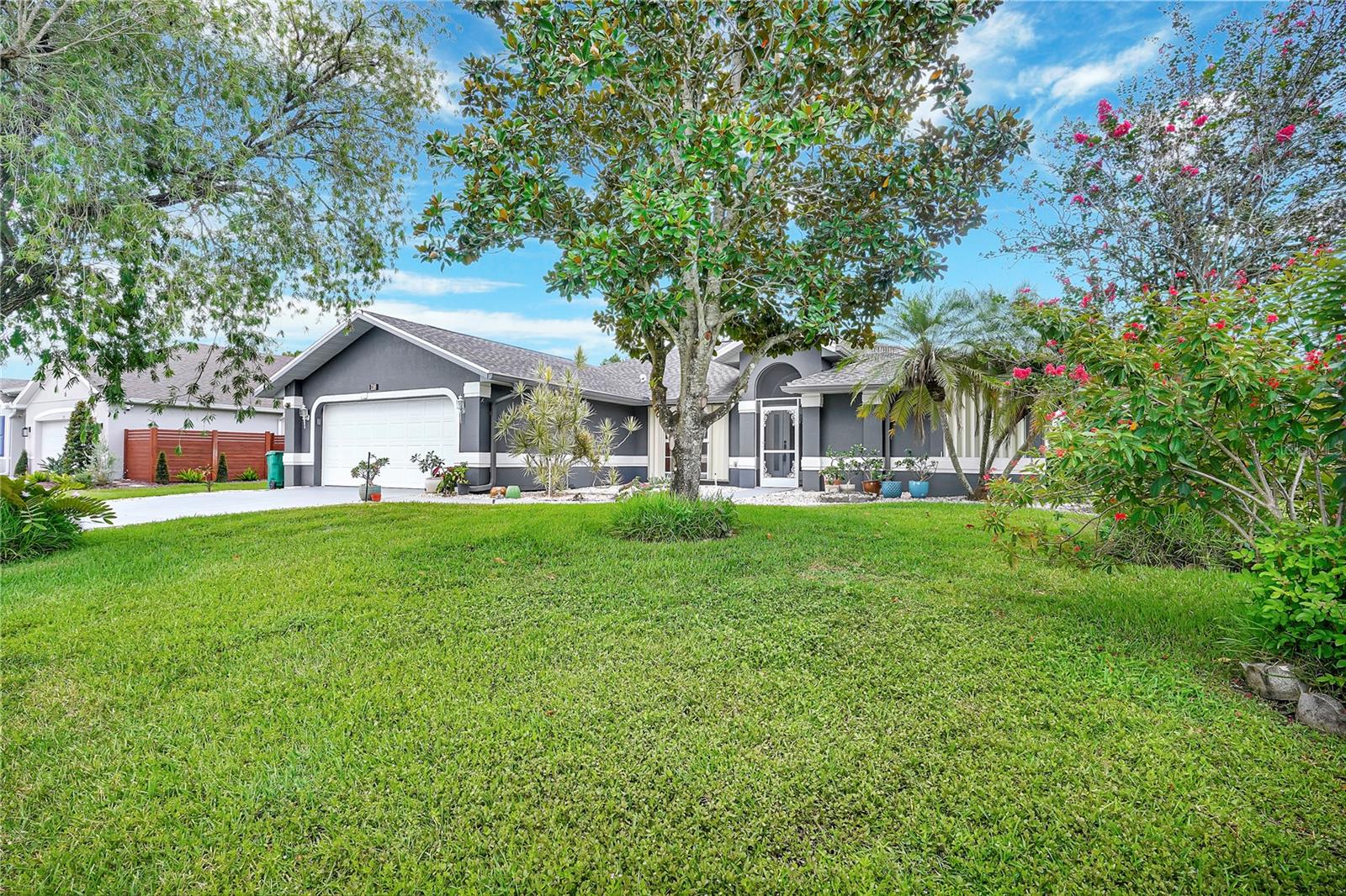 Under contract-accepting backup offers. Welcome to your slice of Florida paradise! This beautifully maintained 3-bedroom, 3-bathroom pool home offers the perfect blend of comfort, functionality, and peace of mind—all nestled on a quiet double cul-de-sac street. Enjoy year-round swimming in your private pool, with sprinklers fed from a well to help keep your lush landscaping green and low-cost. The 2-car garage features a screen enclosure, pull-down attic stairs, and a new garage door motor (2025). Inside, you’ll love the wood flooring in all bedrooms, tile throughout, and corian countertops in the spacious kitchen. The great room, formal living, and dining areas providing excellent flow for entertaining or everyday living. The owner’s suite is a true retreat with a jetted tub, separate shower, bidet, walk-in closet, and linen closet for added storage. Step outside to your covered lanai and take in the serene surroundings of your fully fenced backyard—perfect for relaxing, grilling, or gathering with loved ones. Additional highlights include a 2019 gutters and roof and hurricane shutters for added security. Conveniently located near shopping, dining, and top-rated schools, this home truly has it all.