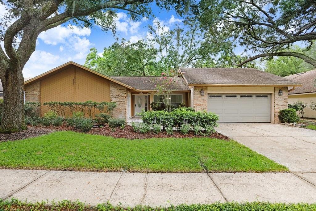 Welcome to this stunning, fully remodeled 4-bedroom, 3-bath pool home with 2,327 sq ft of thoughtfully designed living space in the highly sought-after Lake Magdalene community. From the moment you arrive, you’ll notice the attention to detail and the seamless blend of modern updates with comfortable living, creating a home that is truly move-in ready. Important updates include a newer roof (2016) and HVAC system (2018), giving buyers added peace of mind. At the heart of the home sits the chef-inspired kitchen, featuring gleaming quartz countertops, stainless steel appliances, a generous walk-in pantry, abundant cabinetry for storage, and recessed lighting that brightens every corner. Whether you’re preparing everyday meals or hosting guests, this space delivers both style and function. Just off the kitchen, you’ll find a convenient wet bar, perfect for entertaining, that flows directly into the inviting family room. The family room is anchored by a cozy fireplace feature, accented by a dramatic shiplap wood-paneled ceiling, creating a warm and welcoming space. French doors provide direct access to the pool and outdoor living areas, making it easy to enjoy both indoor and outdoor living year-round. Throughout the home, you’ll find beautiful luxury vinyl plank (LVP) flooring, offering durability and style. The home offers multiple living and gathering areas, including a formal living room with soaring vaulted ceilings, a skylight that brings in natural light, and additional French doors leading out to the lanai. A flexible fourth bedroom/den with French doors provides options for use as a guest room, home office, or media space. The primary suite is a private retreat, with its own set of French doors opening directly to the pool and patio. Dual walk-in closets with custom built-ins provide exceptional storage, while the spa-like en suite bathroom offers dual quartz-topped vanities, a frameless glass shower with all-new tile, a tucked-away toilet, and designer hexagonal floor tiles that add a modern touch. Two spacious secondary bedrooms share a beautifully updated bathroom with a large vanity, quartz counters, and contemporary shower tile. A third full bathroom off the pool adds convenience for guests and outdoor entertaining. Step outside to enjoy the Florida lifestyle at its finest. A large covered patio and screened lanai provide ample room for relaxing, dining, or entertaining, while the sparkling pool is perfect for cooling off on hot summer days. The fenced yard backs to a serene conservation lot, offering peace, privacy, and natural views. This home is not only beautifully updated but also ideally located, with convenient access to downtown Tampa, Tampa International Airport, I-275, shopping, dining, and entertainment. With its modern updates, spacious layout, and incredible outdoor living, this Lake Magdalene gem offers the perfect combination of style, comfort, and location. Don’t miss the opportunity to call this exceptional property your next home!