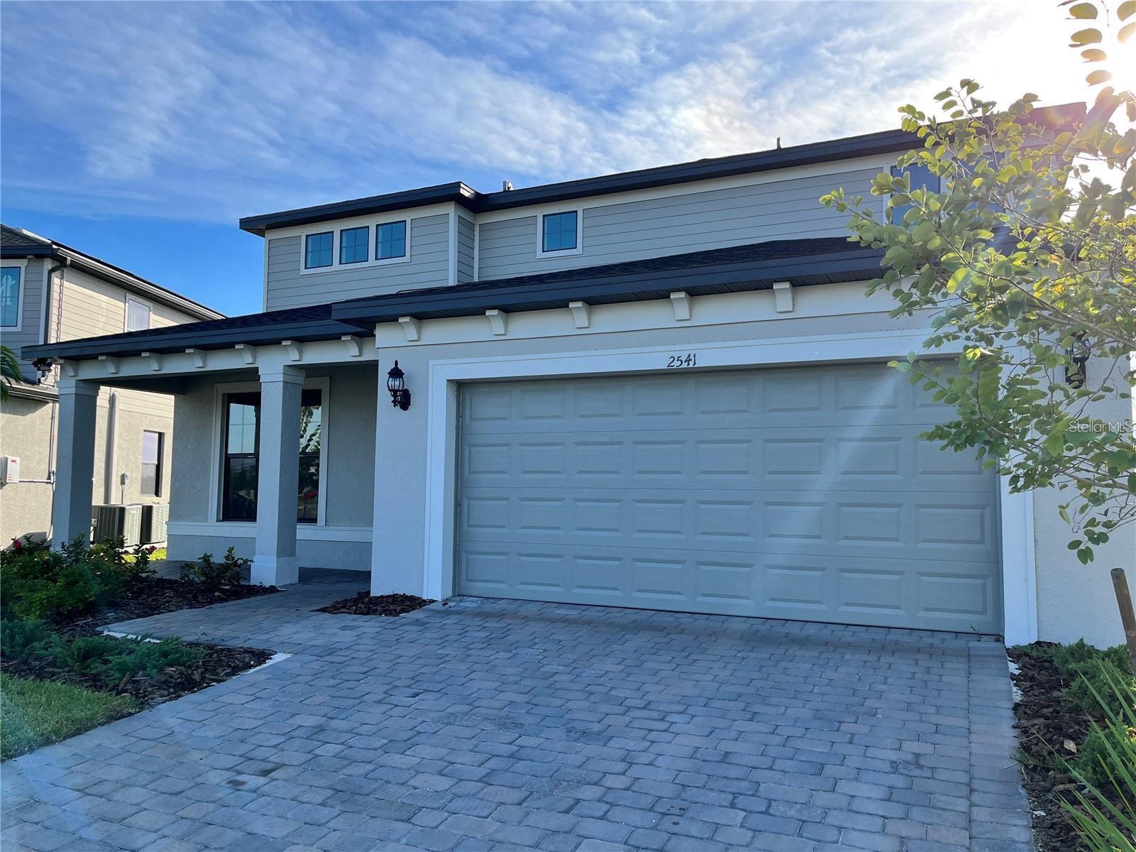 Newer construction! This delightful home in the brand new community of Cedar Grove offers a rare find of 5 bedrooms, 4.5 bathrooms with 2 Bonus Rooms! One can be a playroom and another a media room for the best in movie watching! The moment you walk thru the front door you will be greeted by the gorgeous view of the lake with amazing sunset views. The lake view from the double sliders out to the paved patio will take your breath away. The kitchen offers a large island, eating space in the kitchen with plenty of room for a large table, stainless steel Whirlpool appliances, and upgraded cabinets. The living room/den area are perfect for entertaining. There are two master bedrooms - one on each floor of the home. Each offers plenty of closet space for his/her. Four bedrooms are located upstairs along with the large laundry area for convenience. No running up and down the stairs to put in a load of laundry! Each bedroom has plenty of closet space. The two car garage also offers an EV charger already installed! Just bring your own EV! Lawn care and irrigation are included with your monthly rent. Plenty of natural lighting in this beautiful brand new, never lived in home makes this a must for you to view! Woodland Middle School is very close by. The community offers a pool as well as a park for the littles ones. North Port offers plenty of shopping not far away. I-75 is also a short drive away! Call today to schedule your showing as this rare find will not last.