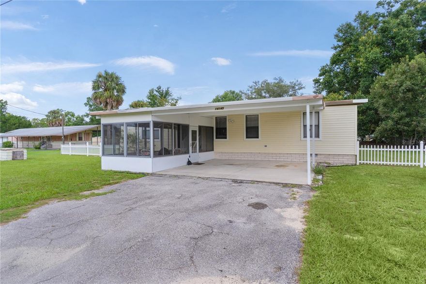 Welcome to this spacious 3-bedroom, 2-bathroom home with 1,352 sq ft, located in the desirable Little Lake Weir neighborhood. This home sits on a .30-acre FENCED lot and includes a SHED and a carport suitable for 2 cars. ROOF 2022. An ENCLOSED LANAI at the front of the home offers additional entertaining space. This TURN-KEY FURNISHED property is perfect for seasonal use, rentals, or simply moving in with just your toothbrush. The Primary Bedroom is generously sized and features a walk-in closet and an ensuite bathroom. Both Guest bedrooms also have large walk-in closets, with a guest bathroom conveniently located nearby. The Kitchen is equipped with ample cabinet space, a New Refrigerator, and Laminate flooring that leads into the dining room. A Washer and New Dryer are included for your convenience. The back SCREENED PATIO serves as a perfect retreat. SELLER CREDIT $5,000 TOWARD FLOORING ALLOWANCE.  This home is conveniently located near Little Lake Weir, Lady Lake, and The Villages, with easy access to shopping, restaurants, medical facilities, and entertainment options.