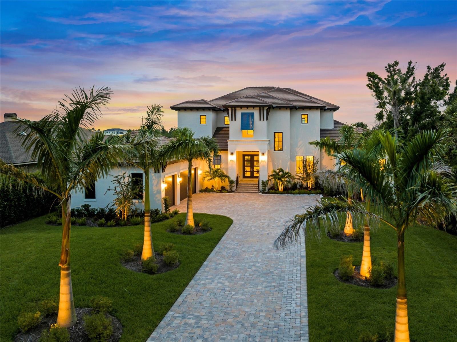 Welcome to 1109 Bayshore Road—an unparalleled waterfront sanctuary redefining luxury living along Florida's captivating Gulf Coast. Masterfully custom-built by the acclaimed John Cannon Homes, this residence embodies the sophistication, craftsmanship, and lavishness reminiscent of the world’s finest five-star resorts. Majestically set behind private gates on over 1.3 pristine acres, every detail of this estate has been artfully curated to provide a lifestyle of unrivaled refinement, tranquility, and indulgence.
From the moment you enter through the gates and travel the elongated paver drive framed by lush tropical landscaping and towering palms, you’ll sense you've arrived someplace extraordinary. Inside, the residence reveals breathtaking bayfront and Intracoastal panoramas from nearly every vantage point. Rich wood plank flooring, polished tile, elevated tray ceilings, and striking eight-foot doorways evoke a sense of grandeur typically reserved for elite luxury resorts. Corner pocket doors vanish effortlessly, blending indoor elegance with expansive outdoor spaces and framing endless vistas of shimmering water.
At the heart of this remarkable estate lies a chef-inspired kitchen worthy of culinary excellence—expertly designed with gleaming quartz countertops, an oversized centerpiece island for unforgettable gatherings, and Viking stainless steel appliances including a professional-grade 48-inch gas cooktop with a vented hood, built-in oven, convection microwave, and an impeccably organized walk-in pantry. A luxurious wine bar area complements the space perfectly, featuring custom cabinetry, elegant shelving, and a built-in beverage refrigerator—ideal for hosting the most discerning guests.
The main-level primary suite is a private oasis, carefully designed for serenity and style, offering mesmerizing water views and direct access to the poolside lanai. Its spa-inspired bath rivals those found in the world’s most exclusive retreats, featuring luxurious finishes, spacious dual vanities, and a walk-in shower with exquisite tile detailing. Additional highlights of comfort include a private elevator granting seamless access to each floor and thoughtfully designed guest accommodations that deliver unparalleled privacy and sophistication.
Outdoors, paradise awaits. The resort-style heated pool and spa overlook breathtaking water views, enhanced by a custom-designed summer kitchen and extensive lanai—perfect for sunset soirées or elegant alfresco dining beneath the stars. A private dock equipped with a 10,000-pound boat lift invites exploration of Florida’s stunning waterways, while the expansive grounds provide ample space to add a guest house or casita, further enhancing the estate’s exclusive appeal.
Located mere minutes from the pristine sands of Nokomis Beach, with convenient access to the charming boutiques, renowned restaurants, and vibrant culture of nearby downtown Venice and Sarasota, 1109 Bayshore Road transcends the ordinary. This residence doesn't just promise luxury—it delivers a lifestyle only experienced in the world's most distinguished five-star destinations.