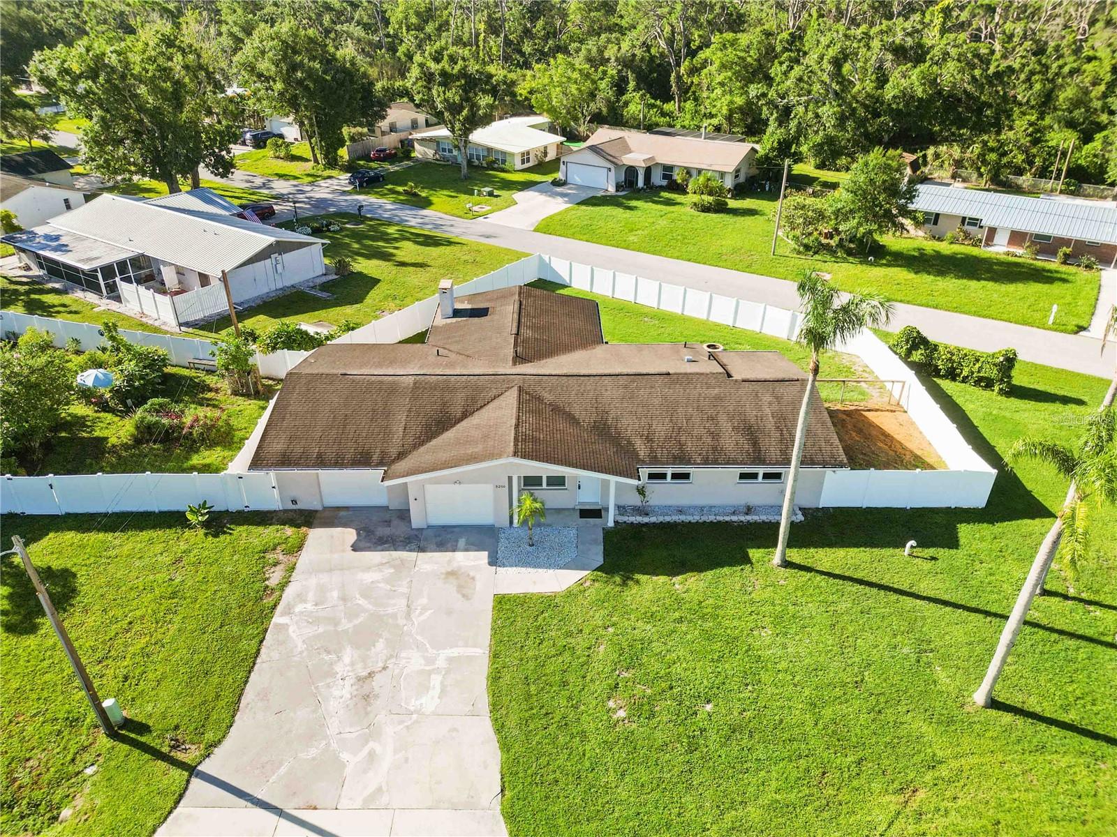 Under contract-accepting backup offers. **Under Contract ~ Accepting Back Up Offers** Your Spacious Retreat Awaits at 5200 Malaga Ave – A Sarasota Home with Enduring Quality and Room to Roam!
Embrace the generous living spaces of this 3-bedroom, 2-bathroom residence, perfectly positioned on a sprawling .32-acre corner lot in a desirable Sarasota location. Boasting 1,878 sq ft, this home, originally built in 1959, underwent a significant and high-quality renovation in 2017, and has been lovingly maintained since.
From the moment you enter, you'll appreciate the fresh, inviting aesthetic, enhanced by a recent interior paint refresh. The beautiful ceramic tile and comfortable carpeting, both installed during the 2017 renovation, contribute to a cohesive and appealing flow throughout. The centerpiece for entertaining and everyday living is the truly spacious 23 x 23 family room, where a warm gas fireplace creates an inviting ambiance for cozy evenings or lively gatherings. The well-designed kitchen, a highlight of the renovation, features lustrous granite countertops, stylish wood cabinetry, and quality appliances, making meal preparation a joy. Rest easy knowing that major components were addressed: a new three-tab dimensional fiberglass roof and a complete new AC system were installed in 2017, providing comfort and longevity. The exterior has also been recently painted. Beyond the interior, the outdoor potential is extraordinary. The expansive corner lot offers unrivaled parking solutions for your RV, boat, or motor home, with easy multi-directional access. Imagine creating your own backyard oasis with plenty of room for a custom pool. The massive 800+ sq ft garage provides abundant storage or space for a workshop. Best of all, there are no deed restrictions, giving you the freedom to truly make this property your own. This home offers exceptional value, combining substantial upgrades with a fresh interior and fantastic outdoor setting! Move right in and start enjoying the Sarasota lifestyle!