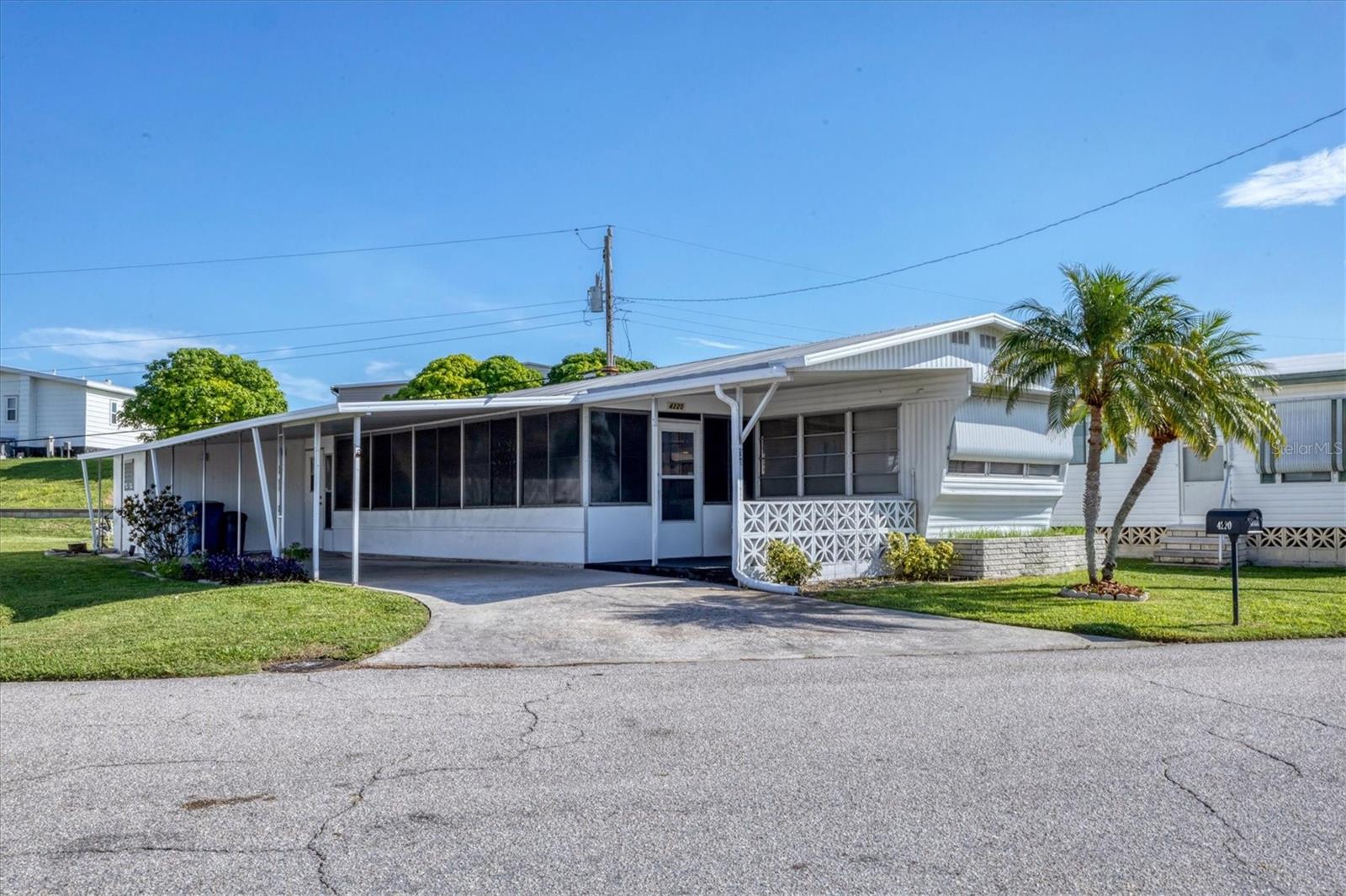 Welcome to Tidevue Estates, an active 55+ LAND-OWNED community where you own your land—no lot rent! This turn-key furnished home is ideally located just steps from the pool and recreational center, offering both convenience and lifestyle. The open floor plan features a versatile office space off the kitchen that can easily be transformed into a formal dining area. The kitchen boasts a cozy eat-in nook and a propane gas cooktop for the home chef. The spacious primary bedroom opens directly to the Florida Room, perfect for morning coffee or evening relaxation. A generous 29x11 divided lanai serves as a second bedroom on one side and an inviting entertainment space on the other. Enjoy the Florida sunshine from your open front porch and embrace the active, friendly atmosphere of Tidevue Estates. Low HOA of only $600 annually. Pets are not permitted. Plenty of activities to keep you busy in this community. Take a water aerobics class in the solar-heated community pool or work on your tan. The community library has free WI-FI connection. Updated fitness center. Meet friends and make new ones for a game of indoor pickleball, bocce ball, or shuffleboard. Join the Golf League. Take a bike or golf cart ride to Veterans' Park to watch the wildlife and sunset. Ellenton Premium Outlet Mall, restaurants, and medical facilities are just minutes away. Easy access to I-75. Not to mention a short drive to our beautiful Gulf Beaches. Don't miss the opportunity to own this charming and modern home in Tidevue Estates!