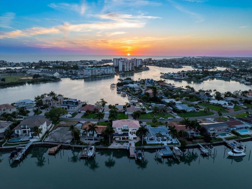 Every now and then, a home comes along that transcends the ordinary – one that distinguishes itself by virtue of a unique location, innovative architectural design and an amazing lifestyle. This is one of those rare times and special places. 
Waterfront coastal living above flood base level in a vibrant, diverse neighborhood setting. Located in Yacht Club Estates just a short distance to beaches, shopping, and dining, this Coastal home features contemporary architecture and unparalleled quality of construction with spectacular waterfront sunset views daily. Enjoy waterfront living at it's best including 16K LB boat lift and dock just a short boat ride to world-class Beaches on the wide open waters oF the Gulf of Mexico. Offering an outdoor balconies and  terrace, and plenty of green space, the living environment is so perfect it will entice you to stay at home. There’s nothing quite like living on the water, especially when you can live it every day! Offering dual master suites one up one down, open floor plan, soaring ceilings, fireplace, bonus space in-law suite, extraordinary Design, quality construction, stunning wide waterfront views, chefs Kitchen, stainless appliances, oversized pantry, split floor plan, custom flooring, oversized 6 car garage, storage,Sauna, so much more even the most discriminating buyer will be pleased.  Located just 25 minutes to TIA airport and close to shopping and restaurants, this location has it all. A paradise for car collectors, families,  boaters and coastal living enthusiasts that enables enjoyment of  the unique charms and appeal of Gulf Beach living everyday. Isn’t this the lifestyle you promised yourself? . You will not be disappointed. Start living your best life call for a private tour before it is gone.