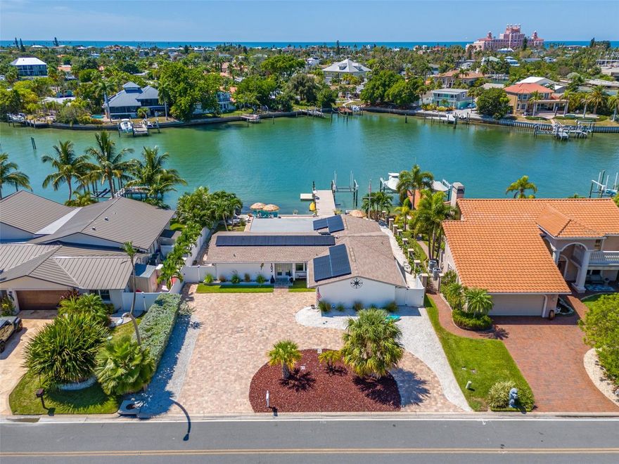 ENJOY BEACH LIVING AT ITS BEST IN VINA DEL MAR, one of St. Pete Beach’s most sought-after neighborhoods! This 3-bedroom, 2-bath, waterfront, pool home has been beautifully remodeled and is ready for you to move in. West-facing water views provide spectacular sunsets. Situated in a private cove of the Boca Ciega Bay, there is minimal boat traffic providing protection to your seawall while still allowing quick and easy access to the Intracoastal and Gulf of Mexico with no fixed bridges. A dock with a 9k lb boat lift, electricity, additional floating dock for easy paddleboard and kayak launching and fish cleaning area is perfect for all your boating and fishing needs.  The minute you step in the front door, you will fall in love with the bright, open views. The finished sunroom not only offers additional living area, but also features a wall of windows, with custom blinds, bringing the sunny outdoors inside. Tasteful updates include beautiful white porcelain tile flooring, remodeled kitchen with white shaker cabinets, quartz countertops and stainless-steel appliances, updated bathrooms, new crown molding, baseboards, interior doors, and hurricane-rated windows throughout. Newly added door off the kitchen area allows easy access to the outdoor kitchen and outdoor dining space with an electric retractable sunshade awning for added comfort. The master bedroom features an ensuite bathroom, walk-in closet with custom closet system and private door that leads to the backyard. The split floor plan provides comfort and privacy with two additional bedrooms and a bathroom located on the opposite side of the house. The spacious second bedroom is plenty big enough for a king-size bed, has an extra-large closet and custom room-darkening blinds. The third bedroom includes a queen-size murphy bed making it perfect for a home office/bedroom, featuring custom room-darkening blinds and a private door accessing the backyard. The fenced backyard is your own private waterfront oasis with a sparkling pool with attached hot tub with relaxing waterfall feature, outdoor kitchen with built-in gas grill and refrigerator, large pool deck with all new pavers, outdoor speakers, ambient lighting and Florida-friendly landscaping. It’s the perfect setting for entertaining, lounging in the sun and enjoying stunning sunsets.  The salt water pool has been refinished and a new pool pump and filter were just installed. The garage offers a laundry area with a newer washer and dryer, abundant storage space and parking for one car or golf cart. Sellers installed a 5-ton A/C unit, which would be sufficient for future expansions to the home.  Additional features include solar panels on roof for lower electrical bills, Generac 22KW whole-house generator, under-sink R/O water system and Insteon SmartHome technology. The circular driveway, with new pavers, allows for easy in and out.  Nearby is Vina Del Mar’s park with Tennis, Pickle Ball, Basketball, playground, fenced dog parks, pavilion, exercise area and benches to enjoy the neighborhood and visit with friends. Vina Del Mar is located in quaint Pass-a-Grille with the beautiful Gulf beaches, restaurants and shopping just a short walk, bike or golf cart ride away, as well as being perfectly located with easy and quick access to vibrant downtown St. Petersburg, the Interstate and airports. Vina Del Mar is the true sense of community with holiday golf cart parades and community gatherings.