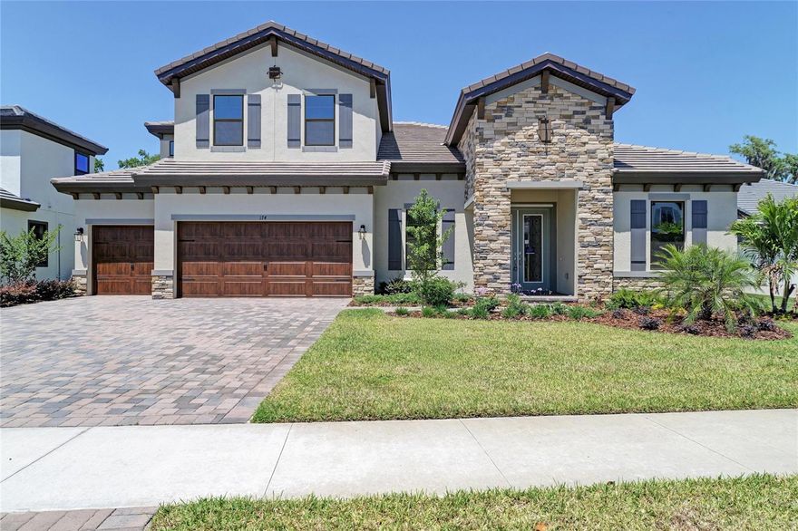 One or more photo(s) has been virtually staged. Key Largo II - 
This Key Largo II home is Ready Now! This home offers a rare chance to own a truly exceptional property in Hidden Lakes, a private, gated community in Brandon, FL. Step inside and discover a meticulously designed interior. The kitchen is a chef's dream, featuring gourmet-style appliances, elegant Maddox Painted Harbor cabinets, and pristine Frost Whte MSI Quartz countertops, all complemented by warm Home Nutmeg LVP flooring. The Key Largo II's two-story layout is crafted for both comfort and grand entertaining, making it perfect for gatherings or everyday family life. Soaring 12-foot ceilings extend throughout the foyer, formal dining room, grand room, and kitchen, creating a dramatic and expansive open plan. The grand room is enhanced by large sliding glass doors, seamlessly connecting indoor and outdoor living, and beautiful wood ceiling beams add a touch of classic charm. The downstairs owner's retreat provides a serene escape, complete with a double door entry, two generous walk-in closets, and a dedicated dressing area. Its primary bathroom is a luxurious spa-like haven, boasting a freestanding tub and high-end finishes. This home also includes versatile spaces like spacious secondary bedrooms, an upstairs bonus room, an oversized laundry/hobby room, and an additional bonus room at the rear, featuring elegant French doors for added flexibility. Enjoy the Florida lifestyle with a spacious covered lanai, ideal for outdoor relaxation. Hidden Lakes offers a desirable living experience within an established neighborhood, showcasing well-appointed floorplans. Every home in this community comes standard with durable tile roofs, attractive paver driveways, and expansive 75-foot wide homesites. This is your chance to own a stunning, designer-upgraded home in a thriving Brandon community.
Images shown are for illustrative purposes only and may differ from actual home. Exterior image shown for illustrative purposes only and may differ from actual home. Completion date subject to change.