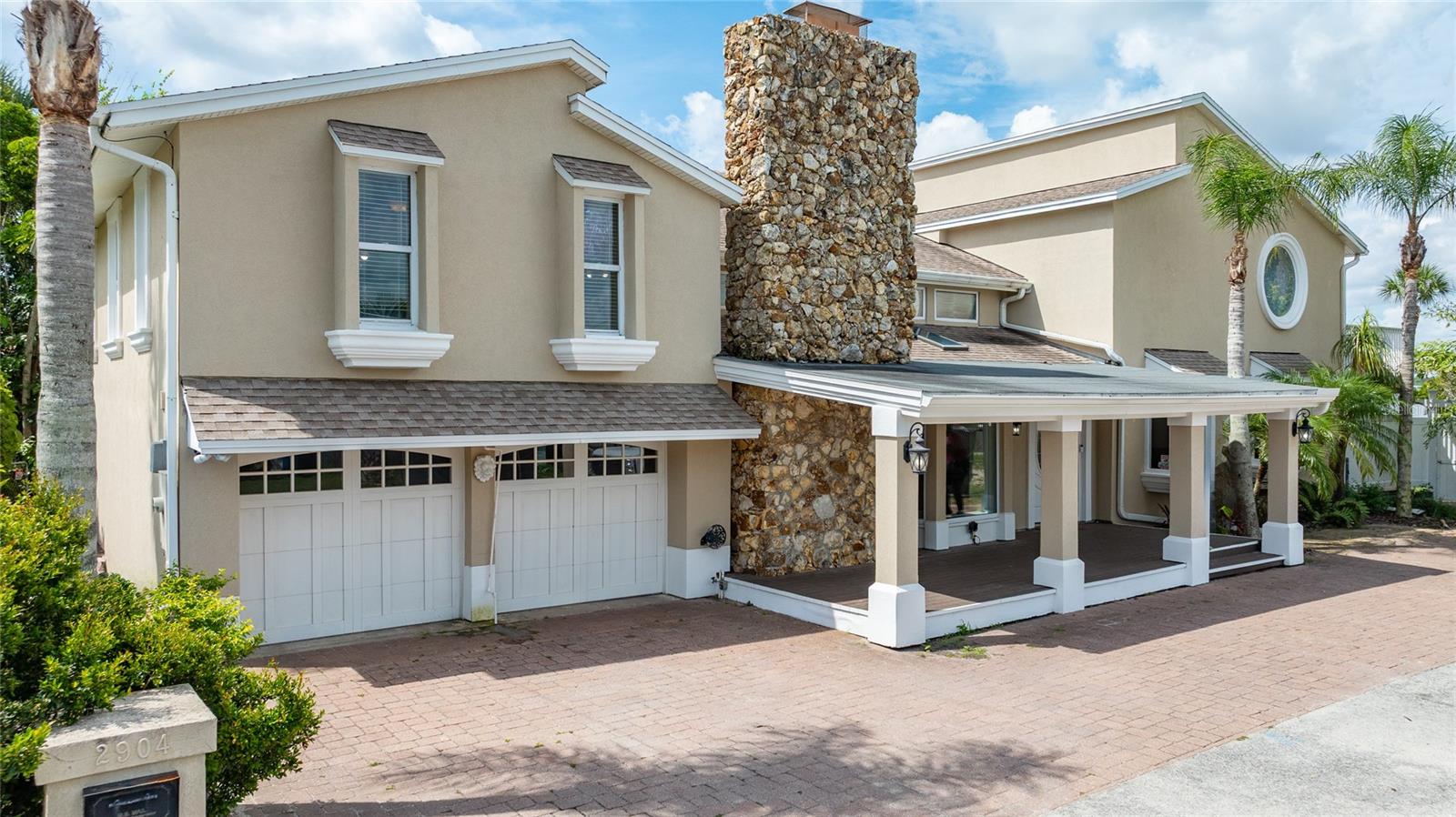Welcome to your dream waterfront home in Daytona Beach Shores! This magnificent 5-bedroom, 5-bathroom property offers an unparalleled waterside lifestyle and a front-row seat to the amazing sunset every evening, but didn't get flooded in any of the recent storms! With a large open living area, and a spacious 0.34-acre lot with 90 foot of river frontage, this home is designed for comfort and luxury. Relax by the refreshing pool with a waterfall and a hidden grotto as you watch the boats and dolphins cruise by the Halifax River.
The main kitchen is a chef's delight, with luxury details and a layout perfect for entertaining, and a bonus entertaining kitchen in the west wing of the home. Most of the home was constructed in 2003 (per permits)
You get not one but TWO Owner's Suites in this home, one on the first floor and one on the second, for a total of 3 bedrooms upstairs and 2 downstairs.
The enormous upstairs primary suite features spectacular river views, a sitting area, an oversized walk-in closet, an en-suite bath with dual sinks and a huge walk-in shower with multiple spray heads, and a riverfront balcony with 180 degree river views and stairs leading to the yard.
A separate 2 bedroom/2 bath suite downstairs (the original 1955 house) provides versatile living space for various family members, in-laws, teens, or guests. Step outside to the pool area, surrounded by lush tropical landscaping, a waterfall, and a cave! The brick paver patio includes a wet bar and offers stunning river views.
Wander out onto your private boat dock and you'll find an electric boat lift, a jet ski floating dock, lighting, and several places for visiting boats to tie off.
Furniture is available for purchase. Short term rentals allowed, verify with Daytona Beach Shores for details.
Imagine hosting friends and family, watching sunset over your dock, and seeing boats passing by – your own tropical oasis!