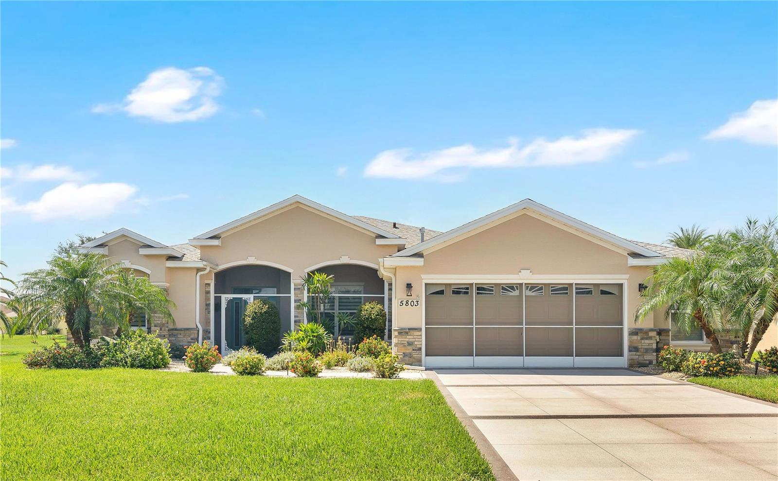 Absolutely breathtaking, a Florida Delight! You won’t want to miss this exquisite 3/2 bath home with a 3 car garage/workshop, in the highly sought-after gated community of Legacy of Leesburg!
From the moment you arrive, the beautifully landscaped exterior and decorative driveway will catch your eye. At night, the landscape is subtly highlighted by accent lighting, creating a warm and welcoming glow. Nestled on nearly a quarter acre in size, this home offers both space and serenity. The striking leaded glass front door floods the entryway with natural light while maintaining privacy.
Step inside and be greeted by the open layout that seamlessly blends the living room, kitchen, and dining areas. Every detail has been thoughtfully designed, from the elegant tile plank flooring to the unique light fixtures and crown molding throughout. The kitchen will delight any chef with its generous counter space, center island with granite countertops, custom wood cabinetry, all newer appliances and a walk-in pantry, making it an ideal space for entertaining guests.
The master bedroom offers a peaceful retreat with plenty of privacy, thanks to the split-bedroom design. The master bath is a luxurious haven, featuring an en suite bathroom with dual sinks, solid surface countertops, custom cabinetry, a walk-in shower, water closet, and a massive walk-in closet with new built in customized shelving that will leave anyone envious.
For outdoor enjoyment, this home offers a trifecta of relaxing spaces: a front screened porch, an enclosed Florida room, and a private back patio enclosed with solar screening. Whether you’re sipping your morning coffee or unwinding with an evening drink, you’ll have the perfect spot to enjoy Florida’s natural beauty.
Rest easy knowing the home is well-prepared for weather events, with hurricane drapes and a Generac generator connected to the home on natural gas. The 3 car garage has a built in 2 door wide Garage screen, Epoxy Painted floors and it is set up as an ideal space for a man cave, in the 3rd bay park your golf cart, motor cycles, start a workshop or Gym- it includes a solar-powered wall vent, mini-split AC/heat system, and ample attic storage accessed by pull-down stairs.
For peace of mind, the home is equipped with a New Roof 2025, New Generac Generator 2024, New Water Filtration System 2024, New Kitchen Appliances including gas range 2024, New Washer and Dryer 2024, New Gas Water Heater 2024, New Interior Paint 2025, New Landscaping 2024. Have a boat or RV? Legacy of Leesburg has onsite recreational parking. Like to swim, play pickle ball or softball, art and crafts, cards or the gym? Legacy has it all including clubhouse activities like dance and aerobics. To top it off it has an exclusive private nature park, nestled right along the peaceful Palatlakaha River. Whether you’re unwinding at a cozy picnic shelter or strolling along one of the many scenic walking paths, you’ll be surrounded by the tranquil beauty of Florida’s lush landscape. No other active 55+ community offers such a perfect blend of serene nature and spacious, peaceful surroundings. Experience the best of retirement living with a lifestyle that combines relaxation, outdoor enjoyment, and the calm of Florida’s open spaces. Hurry it won't last long!