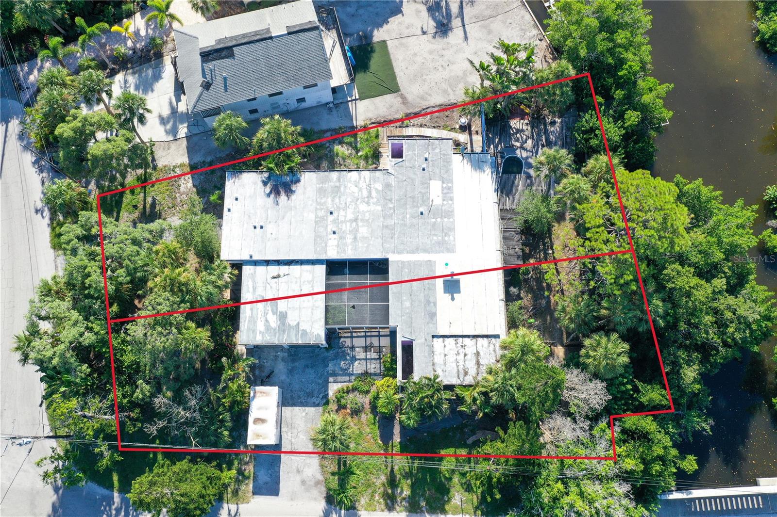 *2 BUILDABLE WATERFRONT LOTS* Palm Island IS the "Heart of Siesta Key". Don't miss this rare opportunity to live in Siesta Key's most sought-after neighborhood and experience the quiet, friendly, yet close to everything community of Palm Island. Build your tropical dream home on one lot and sell the other, or go "all in" and create your ideal island estate on the 17,883 sq ft lot. If restoration is more your style, this home was built using the Lamolithic poured in place construction method developed by John Lambie Jr and was a key design element in the Sarasota School of Architecture. As a result, most of the primary structure and walls are made of 12 inch poured concrete, providing unsurpassed strength and durability. This spacious property located in one of the finest and friendliest communities on Siesta Key is situated a mere 600 feet from arguably the best beach on the planet. Situated on the Grand Canal, it is minutes by boat to the Intercoastal Waterway and a short walk or bike ride to Siesta Key Village. This sought after Palm Island address sits on two county approved building lots and is a rare opportunity for all interests. Maximize your Island experience and treat yourself to this rare, peaceful island escape limited only by your imagination.
