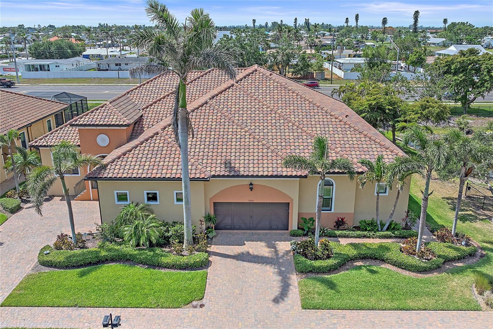 Tucked within an exclusive enclave this stylish villa offers the perfect blend of luxury and location. With over 2,500 square feet, this 3-bedroom, 2-bath pool home features a rare 3-car tandem garage and sits just over 3 miles from the sparkling Gulf beaches. Inside, a calming coastal color palette sets the tone, enhanced by upscale designer details: stone countertops, Italian Bertazzoni gas range, sleek tile flooring, and curated furnishings—including a baby grand piano. The open-concept living area flows seamlessly to a spacious lanai, more like a veranda, overlooking your private heated saltwater pool. The primary suite is a true retreat with a spa-style en-suite bath and custom-designed walk-in closet. Guest rooms are smartly positioned for privacy, complemented by a shared bath with a separate water closet. A versatile den near the entry can flex as a home office, playroom, or formal dining space. Step beyond the gates of this serene community, and in minutes you’ll be basking in the turquoise waters and sugar-white sands of the Gulf Coast. Impact windows and the home sits elevated provide peace of mind for your life along the Gulf. Being sold fully furnished includes everything.