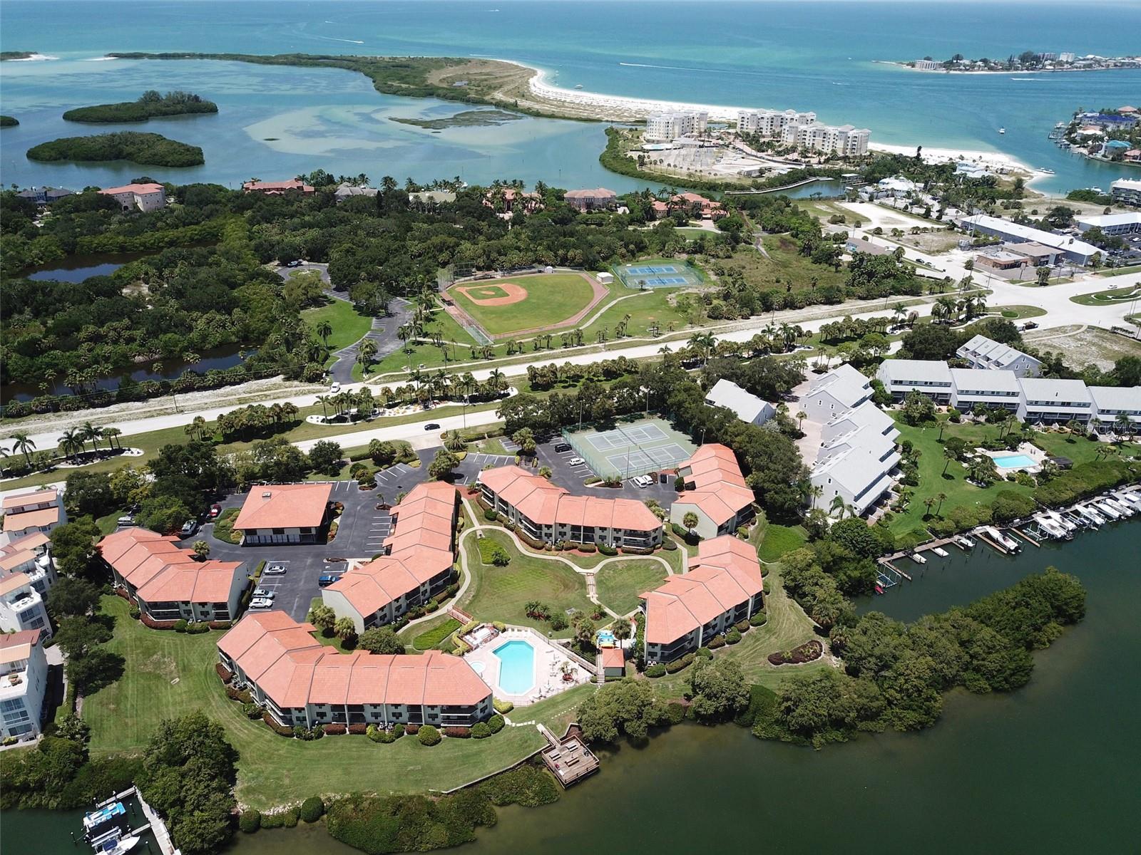 ADDITIONAL $30K PRICE IMPROVEMENT! This condominium subdivision is Exempt from MILESTONE INSPECTION! Looking for 1st/2nd home or profitable investment opportunity? Your piece of paradise awaits! If you enjoy an active, or even laid back lifestyle, The Wander is the place to call home. For investors: these units are rental-friendly with short term, and less than one- week rentals allowed. This waterfront community is one of the most popular and sought after on beautiful Tierra Verde. Nothing to do here but bring your bags. The tastefully, fully furnished 2/2 unit is turnkey. Its clever design uses small space in a big way. An open floor plan combines both the living and dining area. Ready to entertain or book your tenant? Kitchen is stocked with dishes, pots, silverware and ample storage. Enjoy the spacious outdoor porch with picturesque water views. Ceramic tile flooring throughout gives the unit a spacious look uniformed flow. Ceiling fans in both bedrooms and living room. Updated bathrooms with granite countertops (including dual sinks in the primary bedroom.) Primary bedroom with en suite bathroom has plenty of natural light with a wakeup view of the Bay.The Wander is a waterfront community with tons of amenities including: heated pool and spa, lighted pickleball/tennis courts, boat slips for rent, dock, a clubhouse with multi-purpose rooms, fitness room, laundry room, kayak launch and storage area, bicycle storage, and car wash area. Take advantage of the additional amenities including waterfront picnic area with outdoor grill and fishing pier. It is a stones throw away from downtown Tierra Verde and nearby Ft Desoto Park, the Gulf Beaches, shops, restaurants and a quick drive to downtown St. Petersburg. I-275 and U.S. Hwy 19 is a 10 minute or less drive, plus it's only 35 minutes to Tampa International Airport. Don't miss this rare opportunity!