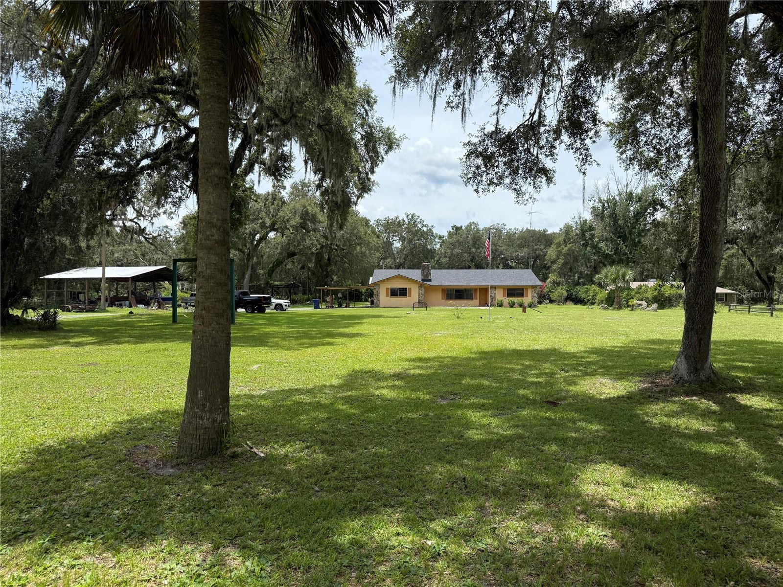Market Adjustment!! Reduced $26K!! 3/2 pool home on 4.9 acres in the country yet minutes from town. Located on a quiet paved county road with minimal traffic. Had new roof installed in 2022. Has large bonus room (24x16) that could easily be converted into a 4th bedroom if desired. Could use a few updates but the "bones" are there. Has 2 polebarns to keep rvs, boats, tractors, or you name it out of the weather. It also has a covered outside grill near the pool. Large grandfather oaks scatter the 4.9 acres. Don't mind the whitetail deer, they're just passing through. Located a couple of minutes from Interstate 75 making commuting a breeze. Only an hour from Tampa, an hour from Orlando, and 20 minutes from The Villages, where you can find shopping, dining, and nightly entertainment. Schedule your showing today.