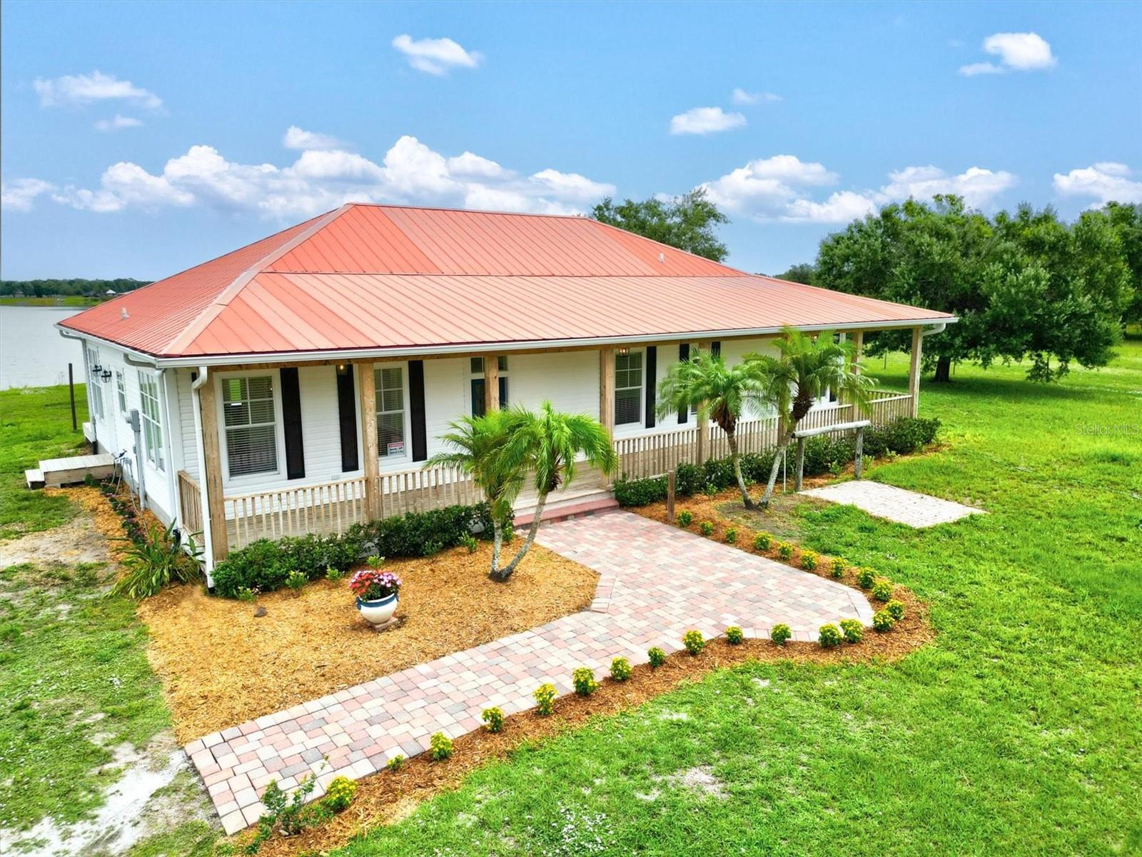 Calling all horse enthusiasts! Bring your magnificent horses to this amazing 6+ acre property with secure fencing. Built in 2004, this cozy home offers 3 bedrooms, 2.5 bathrooms, and breathtaking views of a private community lake spanning 40+ acres. As you make your way towards the large porch, you can't help but notice the meticulously designed and recently added landscaping that surrounds the property, enhancing its beauty and creating a serene atmosphere. Inside, you'll find a living room, formal dining room, and a bonus office or den. The kitchens and bathrooms feature gorgeous granite countertops. The living room and master suite open up to a spacious deck that overlooks the stunning private lake. The master suite boasts double walk-in closets and an upgraded private bathroom with dual sinks, a shower, and a luxurious soaking tub. Additional highlights include an interior laundry room, recently upgraded HVAC systems, and a convenient paver pad for grooming your horse right in front of the inviting full front porch. Don't miss out on this incredible opportunity for you and your horses!