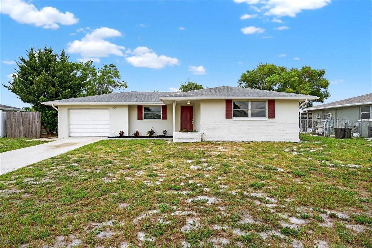 Fantastic 2-bedroom, 2 bathroom home with a 1-car garage located in Jasmine Lakes- on a HIGH AND DRY lot- no flood zone and NOT affected by recent 2024 hurricanes. The spacious backyard is fully enclosed by a private wooden fence—perfect for pets, play, or simply enjoying your own outdoor oasis. Inside, you'll find a functional layout. The master bedroom features two closets and an en-suite bathroom with a stand-in shower. The heart of the home extends to a large, enclosed lanai, ideal for entertaining, relaxing, or expanding your living space year-round. NEW water heater. NO HOA. Great location- a quick 10 minute or less drive to all your favorite conveniences such as clinics, shopping, restaurants, cinemas and other entertainment in Port Richey! Schedule a viewing ASAP!