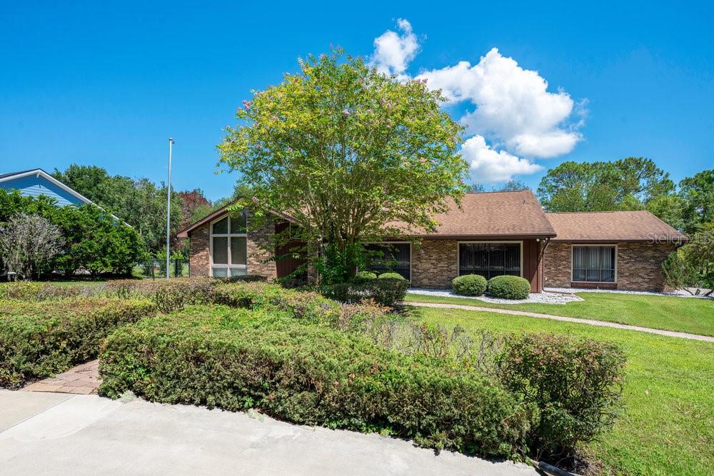 Stunning Custom Brick LAKEFRONT Home – A Rare Gem on .82 Acres! Welcome to your dream lakefront retreat! This impressive 3+bedroom, 2-bath with option for the 4th bedroom/office space/Bonus room, custom brick home is nestled in one of West Volusia’s most desirable waterfront communities, offering the perfect blend of space, style, and serenity. Set on a beautifully landscaped .82-acre lot, the property makes a bold first impression with its circular driveway, oversized side-entry garage, and inviting covered entryway with a stone-floor foyer. Step inside to discover a modern split-bedroom layout filled with natural light and breathtaking lake views from multiple areas of the home. The spacious great room boasts a stunning stone wood-burning fireplace, perfect for cozy evenings, and seamlessly flows into a grand formal dining room with a convenient pass-through window. The chef’s kitchen is a showstopper—featuring granite countertops, custom wood cabinetry, stainless steel appliances, tile backsplash, a built-in desk, and a walk-in pantry—ideal for everyday living and entertaining alike. New porcelain tile flooring (2024) adds a fresh, elegant touch throughout. Enjoy Florida living at its finest on your expansive 35' x 12' screened-in porch or the 442 sq ft open deck, both overlooking the peaceful lake and lush backyard. With three sets of sliding glass doors, indoor-outdoor living is effortless. Additional highlights include Fully remodeled bathrooms, Spacious 15’ x 15’ formal dining room, Generous inside laundry/utility room with sink, cabinetry, and second refrigerator, Architectural shingle roof (2019) Just minutes from the Orlando metro area and Florida’s beautiful beaches, this property combines prime location, timeless design, and tranquil lakefront living. Don’t miss the opportunity to make this exceptional home yours—schedule your private tour today!