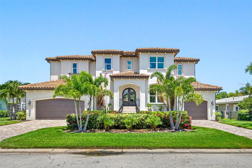 4-year-old custom Venetian Isles waterfront Smart Home offers quintessential upscale living at its finest. Remember the story of the Three Little Pigs? This is the 4th house, the one so solid and well-built that the Big Bad Wolf dare not approach. This raised 4 Bed 5 Bath Superstructure is built on 80 pilings, surrounded by rebar and concrete, down to bedrock ($150K) with over 200 mph hurricane windows and doors. It is built with cinder blocks and concrete on all floors, from top to bottom (not just first floor like most houses). New Seawall. This may be the most indestructible home in Florida! This is not just a beautiful house. This house is built to last. For the buyers that only look at cost per square foot, this is not your home. For the buyer that values high end quality and extras this is your home! 3rd floor Master with its dramatic waterfront balcony overlooking a 61' yacht slip, 12,000 lb lift and a jet ski lift. Master shower has 3 shower heads. It's a private marina with a mansion behind it. Builder Paul Wiezorek designed a literally flawless upscale residence, with the highest kitchen upgrades, water softeners, commercial ice maker, wine fridge, subzero fridge, sound systems, security alarm, 9 cameras w/DVR, privacy and absolutely elegant appointments. Everything is controlled by smartphone apps. Every bedroom has attached bathroom. 3 Bedrooms have walk-in closets. Tons of storage! Walk through the Cathedral shaped steel front doors ($15K) onto hardwood floors, then bright water views in the sitting room/office with fireplace and library. 10' ceilings wandering through the chef-designed kitchen, dining and family rooms. One-bedroom and bath downstairs, including laundry station. Upstairs a second full laundry room, elegant Master bed and bath, two more bedrooms with walk-in closets and private baths. Kitchen offers a large walk-in pantry and small separate office. Garage designed for charging the Golf Cart and your teenager's car? Absolutely. Huge storage and workbench. Here you go! Separate storage room on side of house for boat toys, kayaks, paddleboards, coolers, whatever! Oversized two-car garage for your SUV's? Yep. Walk in, tell Alexa to change the temperature, turn on the dock lights when you're boating home at midnight? She obliges. Dock has two underwater fish lights, two water sources, a fish cleaning station and 100-amp Marina Grade power post. Hurricane sturdy superstructure with beauty and elegance throughout. 5 Ubiquiti Wi-Fi commercial ceiling pucks throughout the house, which also extend to the dock. 2 tankless water heaters. Outside kitchen with BBQ, sink, fridge, and overhead commercial gas heater. Whole house water softener/filtration. Whole house sound system. Landscape lights in front and back. Palms everywhere! Hardwood and granite and crown throughout. Saltwater pool with jacuzzi and LED lights and smartphone control. Motorized blinds outside with remotes. Dual AC. LED lights throughout house. Manatees and dolphins make almost daily appearances in your back yard!! Last but not least, because of our location extending into salt water this neighborhood has almost no mosquitos or noseeums, and the temperature in the summer is 5-8 degrees cooler than Tampa! This home is the perfect combination of design, style, luxury, location, and durability. Hurry... This dream house won’t last! This truly is your “forever” house!