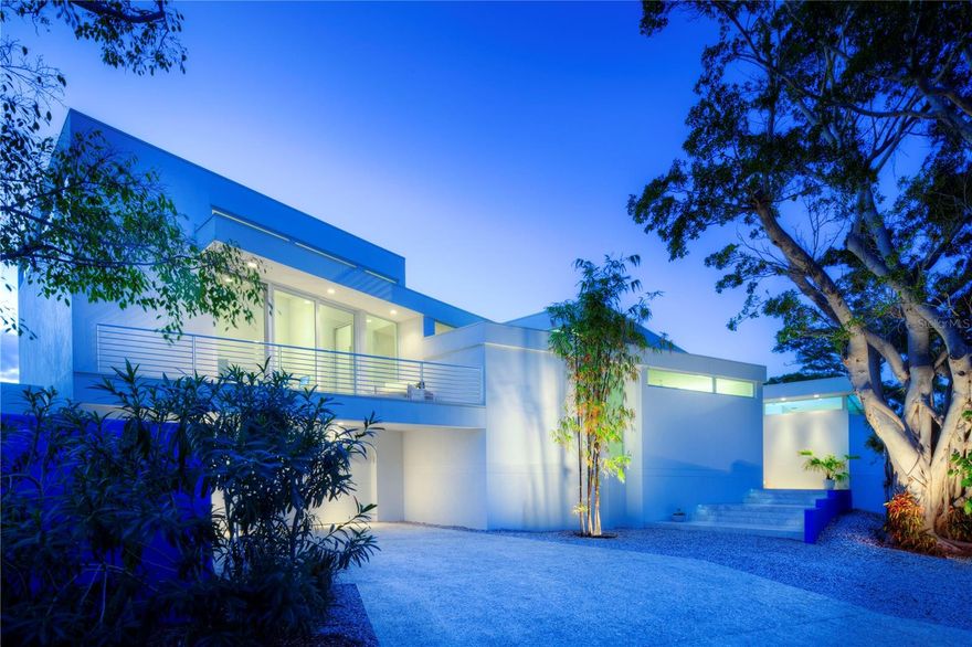 An icon of modern design in the style of the world-renowned Sarasota School of Architecture, 1235 Center Place combines award-winning pedigree with exceptional luxury in a setting that is as coveted for its natural beauty and access to amenities as for its storied mid-century and modern estates. Known as the Light Box House for its distinctive angles and use of glass walls to showcase courtyard and exterior views, this home was custom built in 2012 by the current owners to foster both idyllic privacy and elevated hospitality. The home and architect Jonathan Parks have been widely celebrated for its design, winning the AIA Tampa Bay Merit Award for Architecture and the Grand Aurora Award for a custom home, with features in the Herald-Tribune’s Style Magazine, Sarasota Observer, and HomeDSGN magazine. Occupying the corner lot of Westway and Center and two doors away from the famed Umbrella House, the home is thoughtfully oriented around a central pool that serves as a focal point for both reflection and recreation. Stretching between north and south wings that gently delineate spaces for private retreat and open entertaining, 3,700 A/C square feet encompass three bedrooms with three and a half bathrooms, dual offices, an open concept gourmet kitchen and adjacent dining and living space, all purposefully positioned to capture optimal light and accentuate the interplay of built features with the tropical landscape. An elegant contrast to the brilliant sky and foliage outside, the interior is a refined gallery that meticulously balances walls of glass with solid surfaces for display and function, from art-hung walls to Caesarstone countertops. While complementing the mid-century style of surrounding homes, contemporary construction here offers the significant advantages of elevation for flood consideration, high-efficiency impact rated materials, and modern integrations including heated primary bathroom floor, motorized window coverings, Generac generator, LED landscape lighting, and more. Recent upgrades include two Carrier Infinity HVAC systems installed in 2025 and 2024. Lido Shores is coveted for its concentration of mid-century, modern, and post-modern homes, with masterpieces by Paul Rudolph, Carl Abbott, Don Chapell, and others renowned for their architectural influence. Serene and private but within minutes of St. Armands Circle and Downtown, this special island enclave offers immediate access to the tropical waters of Sarasota Bay and the Gulf and innumerable cultural amenities that include fine and performing arts, dining, and shopping.