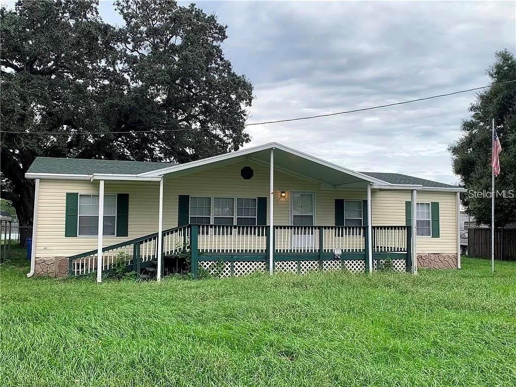 BRING ALL YOUR TOYS- BIKE, BOATS, RV's, & MORE TOYS! MOVE IN READY NOW!! 4 Bedrooms/ 2 Baths with an AMAZING SPLIT PLAN! 2-car carport and barn-style loft shed on over 1/4 acre. NEW SEPTIC & DRAINFIELD in MAY 2021. COUNTY WATER! NEW LUXURY VINYL FLOORING THROUGHOUT! The master suite offers a walk-in closet with private bath including double sinks, garden tub and separate shower. The kitchen boasts a corner walk-in pantry, beautiful cabinets, center island and all appliances. You will love the INSIDE laundry room (6x6), separated by a gorgeous custom barn door. Relax on the 14'x10' covered porch at the front with another 14'x10' covered porch off the back! Completely FENCED with double gates on either side of the home, you can drive a vehicle forward into and out of the back yard with ease. Beautiful large oak offers excellent coverage and shade! Ceiling fans, smoke alarms, and new vinyl flooring. County Water and Septic. Roof and Ac approx 9 years old. Just what you have been looking for on a quiet street with only one way in and out (no drive-thru traffic here). A great location near schools, shopping, restaurants and major roadways like 92 and I-4. No deed restrictions. No HOA and No FLOOD zone. Come enjoy the good life!