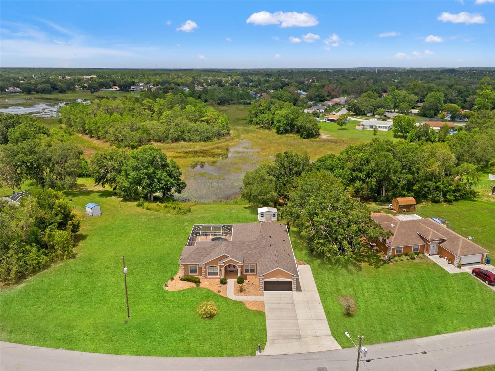 Under contract-accepting backup offers. One or more photo(s) has been virtually staged. Welcome to your Florida dream retreat! If you love hosting or entertaining, look no further! This 3-bedroom, 3-bathroom courtyard POOL HOME is situated on .73-acre Lot in the desirable Spring Hill area! BRAND-NEW ROOF INSTALLED IN 2025! The roof includes a transferable warranty for peace of mind in the years to come and makes it the perfect place to call home!
As you step through the front door, you are greeted by a unique floor plan that centers around the expansive & inviting pool lanai. To your right, the main living area unfolds, showcasing an open layout that seamlessly connects the living spaces. The kitchen boasts beautiful granite countertops, elegant wood cabinets and pantry—perfect for preparing meals. A cozy fireplace in the main living area adds warmth and charm, creating an ideal setting for family gatherings and relaxation. The Primary bedroom is spacious with two closets and an ensuite bathroom featuring a large walk-in shower, garden tub and his and hers vanities. Offering a split bedroom floor plan, you will find a guest bedroom and guest bathroom, in addition to a formal dining room and indoor laundry room!
To the left of the entrance, you'll discover a separate living area that serves as an in-law suite or guest quarters, offering both privacy and comfort. This space includes a bedroom, bathroom with shower, walk-in closet and a small living room which could also be used as an office area, making it perfect for multigenerational living or hosting visitors.
Designed around the pool, this home truly embodies the Florida lifestyle! Step outside to your private oasis, where a sparkling pool with a stone waterfall awaits, surrounded by lush landscaping and ample room for outdoor entertainment. Enjoy the beauty of nature and wildlife visits from various birds such as wild turkeys and sandhill cranes. With no rear neighbors it provides a tranquil setting to unwind after a busy day. The possibilities are endless on this .73-acre lot, as there is plenty of room to bring all of your toys and includes a shed for storage! NO HOA fees and NO flood insurance required, you can embrace the freedom of homeownership without added costs. This remarkable home is not just a place to live; it's a lifestyle waiting to be experienced!!