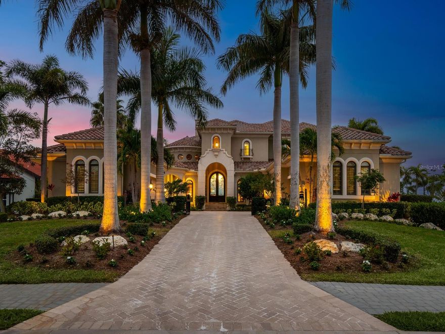 Located in the highly sought-after guard gated enclave of Hawk Island, on the pristine shores of the Manatee River, this home is situated on an estate sized piece of property and located in a private cul-de-sac at the very end of the Hawk Island community. The home offers an expansive stretch of waterfront across both the front and rear of the property. This magnificent estate was inspired by classic Mediterranean architecture and is the epitome of luxury living in Florida. The stately travertine driveway is lined with towering royal palm trees that showcase a grand and inviting entrance. Once inside, your eyes are instantly drawn to a stunning view of the pool and river just beyond a large aquarium glass window. You will find soaring ceilings with decorative moldings, hurricane impact glass, whole house generator and an attention to detail that only the highest quality craftsman can obtain. With 5,842sf under air, this home has 3 newer A/C units (2018) and a newer hot water tank (2021). Additional updates include new interior paint, marble kitchen and primary bath counters, ceramic floors, remote control screens, interior Hunter Douglas blinds, new irrigation and landscape. The open concept kitchen features custom cabinetry and luxury appliances that include ice maker, warming drawer, wall oven and microwave, Sub-zero refrigerator, WOLF Range, and additional beverage and wine refrigerators. Enjoy a fabulous wet bar for entertaining guests and a 288-bottle wine room with iron gate for the wine enthusiast of the family. The kitchen opens up to an inviting family room with 90-degree disappearing sliders that allow you to truly enjoy indoor-outdoor living. Step outside to find a massive covered lanai with outdoor kitchen and a sparkling saltwater pool with water features, pebble tec interior, and integrated spa. The owner's suite occupies its own wing and features double door entry, two massive walk-in closets with custom built-ins, owner's beverage center, and a spa inspired bathroom. Just off the owner's suite is a stately office with a soaring wood ceiling showcasing beautiful custom built-ins. On the opposite side of the house, you will find two stately and private en-suite bedrooms. Oversized laundry room, powder room, and pool bathroom complete the first floor. Take the stairs or choose to ride the Elevator... On the second floor you will find a second owner's suite with balcony access, and an impressive bathroom featuring designer tile and upgraded fixtures. Stay home and watch a movie in the professionally installed sound proof home theatre. The second floor also features a bonus room with pool table, 4 TVs, bar area and upstairs kitchen, and another set of 90 degree disappearing sliders that open to the upstairs balcony overlooking the pool and river... Watch the most spectacular sunsets from the best view in Hawk Island! The riverfront observation deck and canal boat dock are constructed of low maintenance Trex decking and feature 2 boat lifts(6,000lb and 24,000lb), 2 jet ski lifts, fish cleaning station, and storage shed. Boat to the Gulf of Mexico in 20 minutes! 5 CAR GARAGE for the car enthusiast in the family.