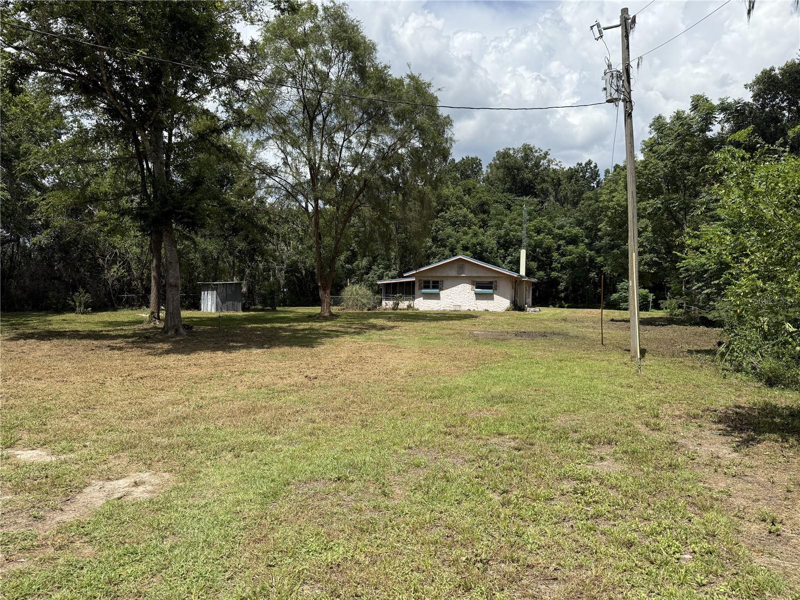 Limited time opportunity! Seller will be reviewing all offers no later than July 31st. Opportunity knocks with this expansive 1.9-acre property featuring a 3-bedroom, 2-bath double-wide manufactured home. While the home needs some repair, the true value lies in the land. Zoned A-1 for agricultural use, this generous parcel offers the freedom to explore farming, investment, or a fresh start with a custom-built residence. Whether you're a land buyer seeking flexibility or an investor with vision, this property delivers space, A-1 zoning advantages, and boundless possibilities. The property location also offers quick and convenient access to shopping, dining, public parks, medical facilities, and a short drive to The Villages. Outdoor enthusiasts will also enjoy a variety of amenities and attractions within easy reach, such as Santos Trails, a popular destination for hiking and biking, the Florida Horse Park, and Baseline Golf Course, just over one mile away.