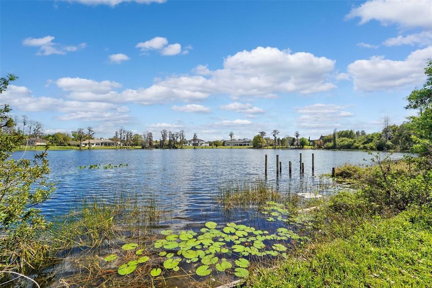 Located in Odessa’s highly sought-after Lake Keystone area, 18709 Wayne Rd offers a rare opportunity to secure a valuable lakefront homesite surrounded by some of Northwest Hillsborough County’s most impressive custom estates and multi-million-dollar waterfront residences. This coveted stretch of Odessa has become known for its expansive lakefront properties where luxury homes valued well into the seven-figure range line the shoreline, creating a setting that reflects both prestige and long-term value. The true value here lies in the land and the exceptional setting—an increasingly rare chance to own a sizeable lakefront parcel in one of the Tampa Bay area’s most desirable waterfront communities. The property spans approximately 1 to 1.5 acres (with a portion extending into the lake), offering ample space to design and build a custom lakefront residence that takes full advantage of the water views and natural surroundings. Mature trees, wide open lake vistas, and the generous lot create the kind of setting discerning buyers seek when building a luxury estate. The Lake Keystone area is widely recognized for its large homesites, private waterfront estates, and a collection of striking custom homes that contribute to the area’s reputation as one of Odessa’s premier lakefront enclaves. Many neighboring properties showcase significant architectural investment and high-end design, reinforcing the strong desirability and enduring value of the community. The property currently includes an existing residence along with a true Cold War–era conversation piece—an above-ground mid-century bomb shelter. With a little imagination, this unique structure could be repurposed as a workshop, studio, secure storage space, wine cellar, hobby room, or simply remain a one-of-a-kind feature that sparks conversation with guests. Despite its tranquil, estate-like setting, the property is conveniently located just minutes from the Veterans Expressway, providing easy access to Tampa International Airport, downtown Tampa, shopping, dining, and the greater Tampa Bay area. Opportunities to acquire lakefront land of this size in the Lake Keystone area—especially among surrounding luxury estates—are increasingly rare. Whether renovating the existing home or creating a new custom residence, this property presents the chance to establish a signature lakefront estate in one of Odessa’s most iconic waterfront communities. DO NOT STEP ON THE REAR DECKS — THEY ARE UNSTABLE AND UNSAFE.