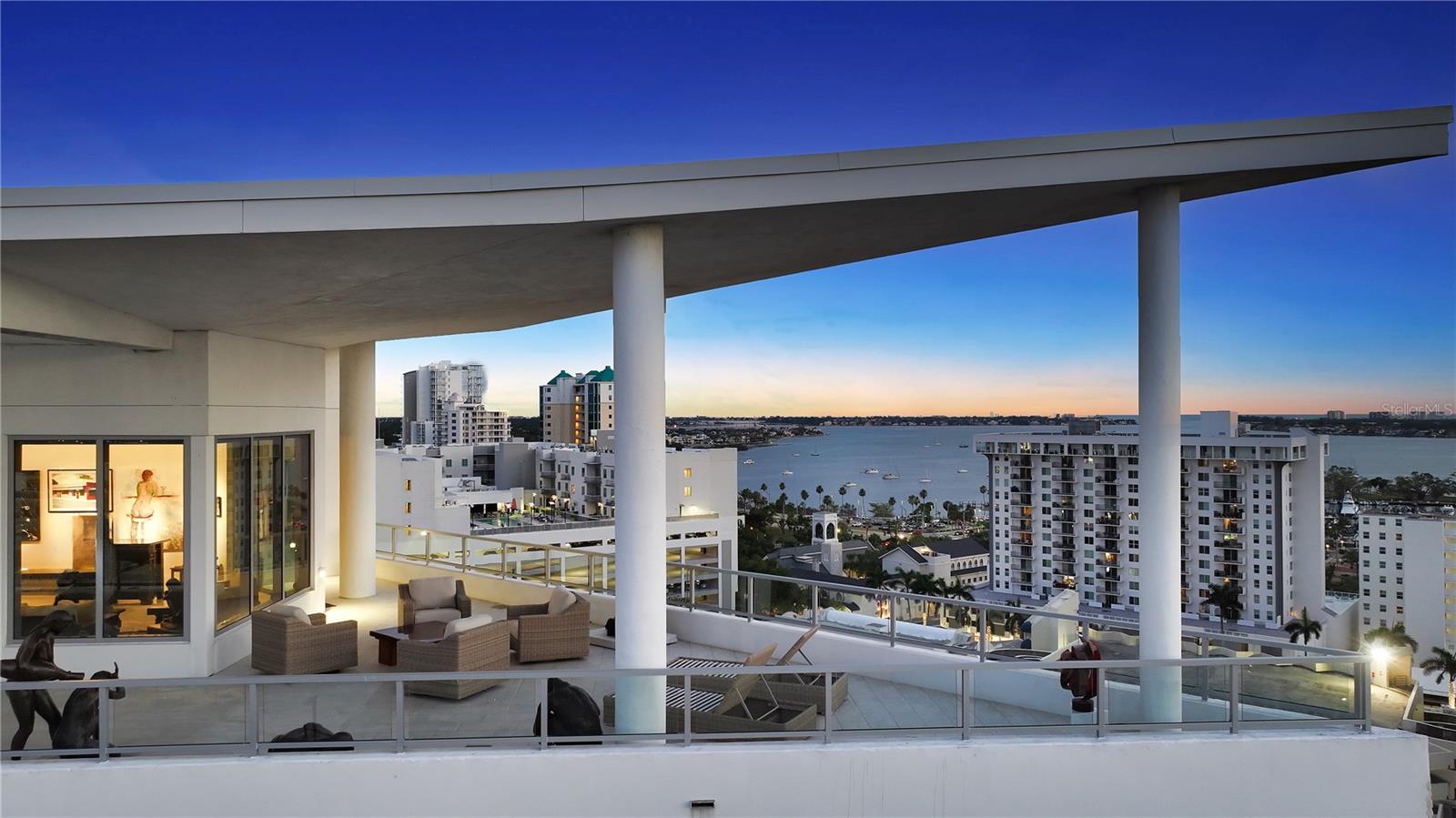 Sky-High Sophistication in Downtown Sarasota...Discover the pinnacle of luxury living in this rare penthouse condo with 2,803 square feet of modern elegance with panoramic bay views in the heart of Downtown Sarasota. This 3-bedroom, 3.5-bath residence stuns with floor-to-ceiling windows, a dynamic open layout, and designer finishes throughout. The main living area is built for both luxury and comfort, with sweeping views and natural light that transform every sunset into a private spectacle. The chef’s kitchen features sleek European cabinetry, premium appliances, and an oversized island—ideal for entertaining or quiet evenings in. The primary suite is a true retreat, complete with a spa-caliber en-suite and unobstructed water views. Two additional bedrooms with privacy and style for guests or family. Step outside to a impressive 1,450-square-foot wraparound terrace—your private perch for al fresco dining, lounging, and stargazing. Just floors below, access the exclusive amenities for the building. Downtown Sarasota offers a vibrant mix of dining, shopping, and culture—steps from your sky-high sanctuary. This is more than a residence—it’s a lifestyle where city energy meets water view calm, and every evening ends with a front-row sunset.