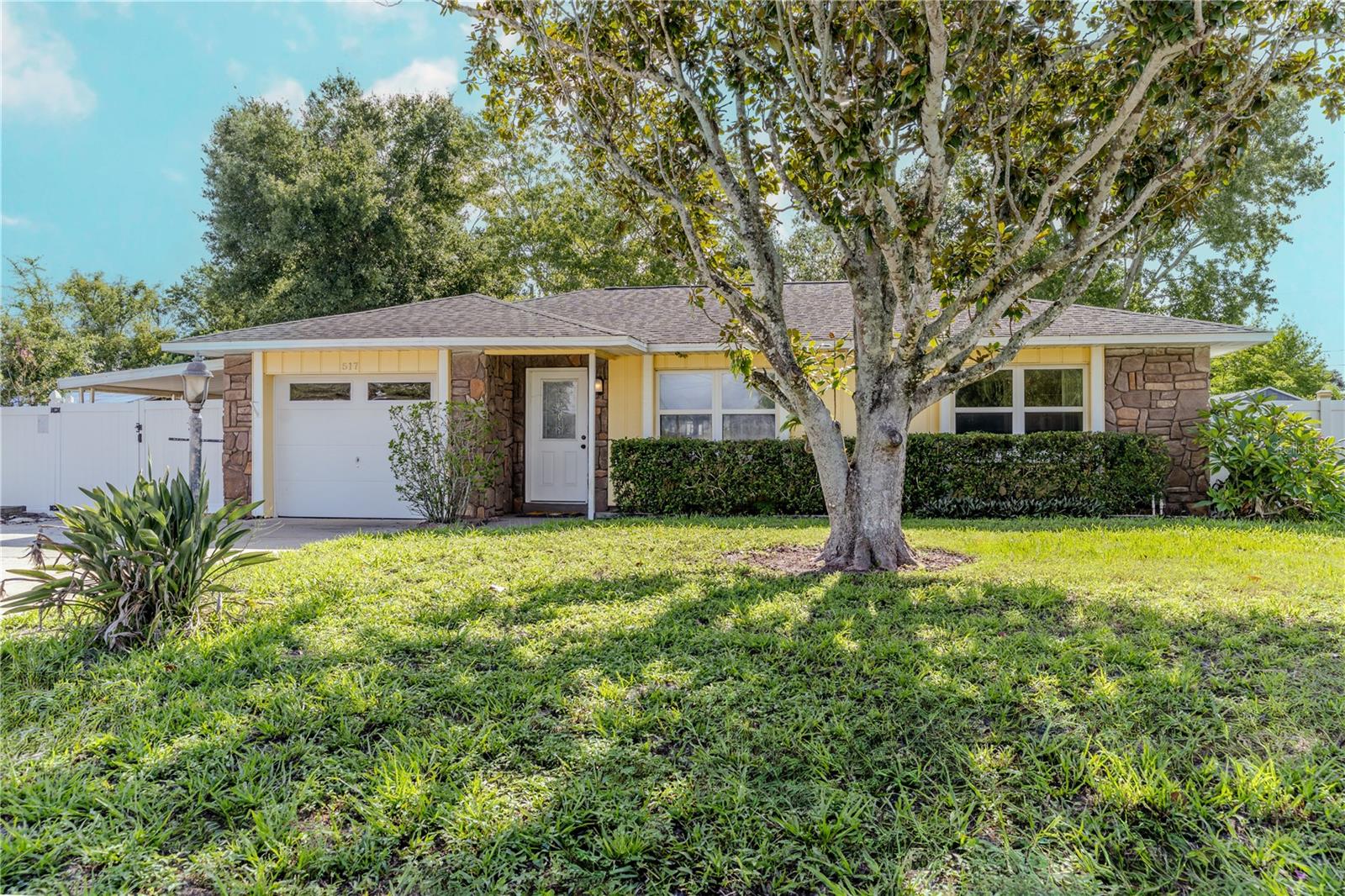 One or more photo(s) has been virtually staged. Nestled on nearly a quarter-acre lot, this charming two-bedroom, two-bath gem offers a perfect blend of comfort and modern living. As you step inside, you’ll be greeted by a bright and airy open concept layout, accentuated by ceramic tile flooring that flows seamlessly throughout the home. The heart of this residence is undoubtedly the stunning kitchen, featuring granite countertops, stainless steel appliances, and a spacious closet pantry—perfect for culinary adventures or casual dining. The thoughtfully designed bathrooms add a touch of luxury to your everyday routine, with one boasting a chic stand-up tile shower complete with a rain head showerhead, while the other offers a relaxing tub and shower combo for those peaceful evenings. Slide open the glass doors to reveal a large screened-in porch, where you can unwind and enjoy the gentle breeze while overlooking your fully fenced yard. This outdoor space is perfect for entertaining, gardening, or simply enjoying the tranquility of your private sanctuary. The yard is fully enclosed, complete with a front gate that leads to two covered parking spots, ensuring convenience and security. In addition to a large single-car garage equipped with laundry facilities, this property comes with the added benefit of NO HOA, giving you the freedom to make this house truly your own. Located just 10 minutes from Interstate 4, you’ll find yourself conveniently close to a variety of restaurants, shopping options, and recreational activities. Plus, enjoy the sun-soaked shores of Daytona Beach, just a quick 30-minute drive away. Don’t miss out on this incredible opportunity! Schedule your private tour today and experience the warmth and charm this home has to offer. Your new adventure awaits!