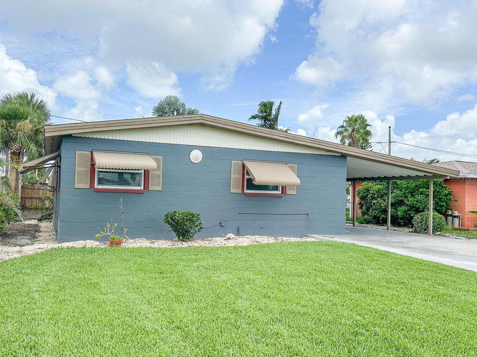 Completely Renovated Mid-Century Modern Gem in Waterfront Community! Step into timeless style and modern comfort in this beautifully updated 2-bedroom, 2-bath mid-century modern home just 5 minutes from the beach. Located in a desirable waterfront community with a waterfront neighborhood park, this home is also steps to restaurants, bowling, grocery stores, and the hospital—the perfect blend of convenience and coastal living. Inside, you'll find stunning vaulted ceilings, an open-concept new kitchen with sleek finishes, and indirect lighting in every room that enhances the architectural charm. The sunroom is filled with natural light and the entire home is protected by hurricane-rated windows, making it a relaxing retreat year-round. Both bathrooms have been completely remodeled, featuring beautiful tilework and stylish new vanities. The home has undergone a full professional remediation and rebuild following minor flooding from Hurricane Helene—everything has been done for peace of mind. Additional features include a spacious carport, a large attached laundry room, patio, large backyard with room for pool, and incredible walkability and bike-ability, including easy access to world-famous St Pete Beach. Don't miss this opportunity to own a move-in-ready home in one of the area's most sought-after coastal communities!