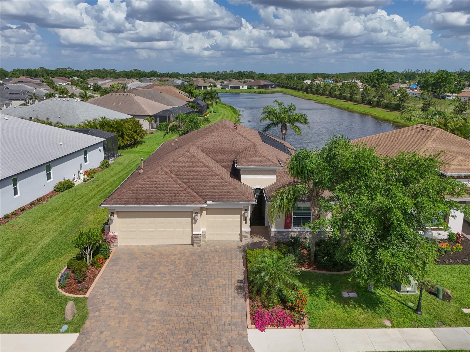 Back on the market! Buyer's financing fell through . PRICE IMPROVEMENT. Stunning 3-Bedroom Home with POOL and LAKE VIEW in the Desirable Greyhawk Landing Community
Welcome to this exceptional Sam Rodgers Captiva model, located on a quiet cul-de-sac. This immaculate 3-BEDROOM, 2.5-BATH home, complete with a DEN/OFFICE, offers a perfect blend of elegance, luxury, and comfort in the highly sought-after 24-hour gated community of Greyhawk Landing.
As you enter through the upgraded glass front door, you are greeted by a spacious OPEN FLOOR plan featuring 12' tray ceilings and crown molding, creating a sophisticated atmosphere. The gourmet kitchen boasts an OVERSIZED QUARTZ ISLAND, soft-close cabinetry, stainless steel appliances, a gas range, and a walk-in pantry.
The great room features DISAPPEARING SLIDING DOORS, seamlessly extending the living space to the SCREENED LANAI WITH BREATHTAKING LAKE VIEWS. Enjoy stunning sunrises while relaxing by the SOLAR-HEATED POOL. The brick-paved lanai adds an extra touch of elegance to outdoor living.
The spacious primary suite features a tray ceiling, a LARGE WALK-IN CUSTOM CLOSET, and a luxurious EN-SUITE BATH WITH DUAL SINKS an OVERSIZED FRAMELESS RAIN-GLASS WALK-IN SHOWER. The second and third bedrooms are well-separated for privacy and generously sized. A versatile den/office provides flexibility for work or leisure.
This home is equipped with high-efficiency systems, including a 16 SEER heat pump, humidity control, IN-WALL PEST CONTROL, and a reclaimed water system, ensuring comfort and sustainability year-round.
Greyhawk Landing’s amenities are second to none, with two resort-style pools, a spa, fitness center, tennis, pickleball, and basketball courts, a playground, soccer and baseball fields, fishing ponds with a pier, and scenic walking trails. The community also offers two elegant clubhouses for gatherings, fitness classes, and social events.
Conveniently located near top-rated schools, dining, shopping, and recreational opportunities, this home is just minutes from Lakewood Ranch, downtown Sarasota, I-75, SRQ Airport, and the world-famous beaches of the Gulf Coast. "House is currently unfurnished"