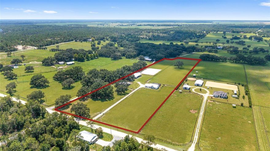 Back on the market. Buyers home sale fell through. Now is your chance to grab it before someone else does.  Welcome to this charming 10.40-acre equestrian retreat in Williston, Florida, where functionality meets farmhouse charm. From the moment you arrive at the gated entrance—complete with elegant stone columns—you’ll feel the pride of ownership and thoughtful planning that went into every inch of this stunning property. A long driveway leads past lush fenced pastures to the heart of the farm, where a 2022-built center aisle horse barn and a modern farmhouse-style home await. The 48' x 48' center aisle barn features 8 stalls, 4 with private turnout pens and end gates for easy access to the pastures. There’s a wash rack, two flexible open bays that can become additional stalls or hay storage, and a 12' x 24' insulated, air-conditioned tack room with a 5' roll-up door—ideal for moving your tack and feed in comfort. Rubber flooring throughout the aisle, stalls, and tack room adds to the functionality and ease of maintenance.
For the equipment or hobby enthusiast, a second 40' x 84' pole barn (also built in 2022) offers five open bays with an additional 12' x 60' overhang—perfect for tractors, trailers, or RVs. A 24' x 40' enclosed garage with two large roll-up doors provides space for a workshop, toy storage, or additional farm use. In addition, you have 200-amp electric service to the home and both barns, plus two RV hook-ups (one 30amp & one 50amp) and dual electric meters, this property is designed for versatility. At the top of the farm sits the quaint 3-bedroom, 2-bath home, built in 2022 and overflowing with charm. The farmhouse kitchen features stainless steel appliances, glass backsplash, a center island, and bar seating that opens to the spacious living area. A retractable glass wall extends your living space onto the screened lanai, which features a heated saltwater pool (added 2023), all facing west for breathtaking sunsets after a long day. This split floor plan offers a private master suite, while the 3rd bedroom, complete with sliding barn doors and Murphy Bed doubles as an office providing work-from-home potential. Another great feature of the home is a 24' x 36' attached 3-car carport making everyday access convenient rain or shine.
Enjoy panoramic views of your horses from nearly every window. Four large pastures surround the home, and the fifth pasture features a riding arena, ideal for any discipline. Tucked away in peaceful countryside yet still just 6 miles to Williston, this property offers the best of both worlds. You're also 20 minutes to the HITS showgrounds, 25 minutes to the World Equestrian Center, 35 minutes to Gainesville, 30 minutes to Ocala, and less than an hour to the Gulf of Mexico for beachside escapes and fishing adventures.
Whether you're training, relaxing, or entertaining, this turn-key farm has everything you need to live the equestrian dream. The sunsets here are unforgettable—and so is the opportunity.
