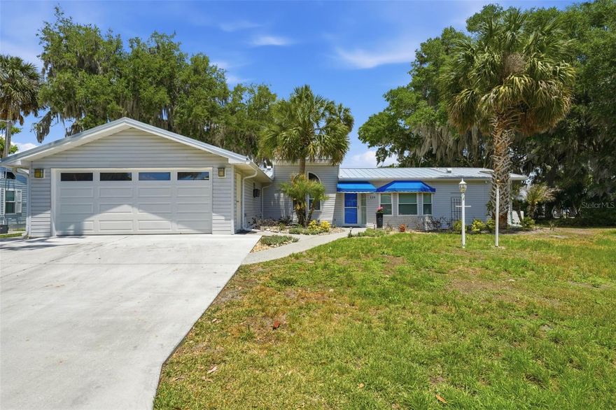 Welcome to elevated lakefront living on beautiful Lake Yale—where comfort, design, and a true Florida lifestyle come together in this exceptional 3-bedroom, 2-bath home featuring both a welcoming living room and a spacious family room with stunning lake views.

Perfectly positioned along the shoreline, this property offers a rare and highly sought-after feature—your own sandy beach area. Step outside and feel like you’re on vacation every day, with soft sand underfoot, peaceful lake views, and breathtaking sunrises that light up the water each morning.

Inside, the home opens to a bright, airy floor plan enhanced by skylights and natural light throughout. The layout flows effortlessly between the living room and the expansive family room, creating multiple spaces to relax, entertain, and fully enjoy the waterfront setting.

At the center of the home, the gourmet kitchen has been beautifully updated with quartz countertops, a designer backsplash, soft-close drawers, pantry, and a new sink with disposal. And here’s the detail buyers never forget—the view from the kitchen sink is simply unparalleled, offering a direct, unobstructed look out over the lake while you cook, clean, or gather with guests.

One of the standout features is the enclosed lanai designed as true extended living space. With insulated windows and tall slider panels that open to screens, you can easily transition between climate-controlled comfort and fresh lake breezes. Whether closed for year-round use or opened up to enjoy the outdoors, this space becomes the heart of the home—perfect for morning coffee, evening dinners, or entertaining guests.

The custom bar area adds a distinctive, upscale touch with a live-edge wood countertop, bringing natural character and warmth into the space. Just beyond, a concrete patio offers a front-row seat to the water, peaceful surroundings, and even the occasional rocket launch in the distance.

Located within Sandpiper Co-op, a resident-owned community recognized by the State of Florida as real property ownership, you’re not just buying a home—you’re owning a share of the entire community. Residents enjoy access to a pool, marina, shuffleboard courts, clubhouse, community dock, covered boat slips, and a sandy beach, creating a true resort-style lifestyle on Lake Yale.

An oversized two-car garage provides ample space for vehicles, storage, or hobbies—an added bonus rarely found at this level.

Set on a large, quiet lot with premium lake exposure, this home offers privacy, beauty, and a lifestyle that feels elevated at every turn. This is more than a home—it’s a lakefront experience designed for the way you actually want to live.