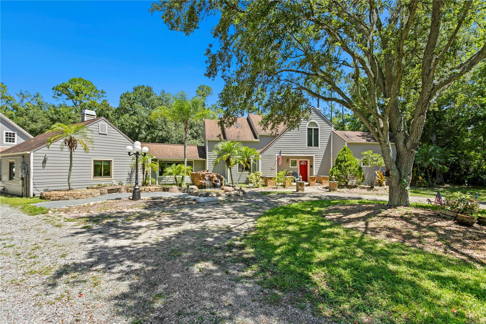 Nestled deep in the peaceful back corner of Twin Branch Acres, this hidden gem on Bronco Drive feels like a world of its own. Set on 1.49 private, wooded acres and surrounded by towering trees, this one-of-a-kind retreat offers space, serenity, and personality. In an X flood zone, the means NO flooding back here.
Just minutes from Westchase, yet far from the ordinary. Twin Branch Acres is beloved for its horse-friendly charm, oversized lots, and custom homes, and this one truly stands apart.
A pebbled driveway leads to a circular front drive and continues past the home to an impressive two-story detached garage with space for 4+ vehicles, a workshop, or future guest quarters. A handcrafted waterfall greets you at the entrance of the main home,
where thoughtful design and warmth unfold. As you step inside, the formal living and dining room offers a spacious feel, the first of two wood-burning fireplaces, a convenient half bath, and French doors that open to the lanai and pool area, creating a seamless indoor-outdoor flow. The layout includes five bedrooms and three and a half baths, with the primary suite privately tucked away on the first floor. This primary bedroom offers high ceilings, a spa-like bath, a walk-in closet with custom built-ins, and a recently updated impact slider for private access to the outdoors. The kitchen is full of charm and function, with Granite natural edge countertops, newer stainless-steel appliances, a wine fridge, and a built-in breakfast nook. A pass-through window connects to the lanai, and just off the kitchen, a second living room with another fireplace and bay window invites you to unwind. Passing through the living room, an impressive private guest suite with its own full bath and separate entrance provides ideal space for guests or games, theater, or music. Maybe a home office. Upstairs, three additional bedrooms and a full bath offers flexible living, work, or hobby space. Outside, enjoy a screen-enclosed, handcrafted, grotto-style pool, handcrafted outdoor kitchen, and both gas and wood-burning fire pits, perfect for entertaining or peaceful evenings at home. The fenced yard offers space for furry friends to roam.
Recent upgrades include a whole-house Generac generator, impact windows throughout, a new slider in the primary suite, fresh exterior paint, and a clean pre-listing 4-point inspection. With a voluntary HOA, country-style quiet, and room to truly breathe, this property is a rare blend of privacy, character, and practicality. If you're looking for something truly special, this is where your search ends and your next chapter begins.
Check out the floor plan and 3D tour by clicking video tour
