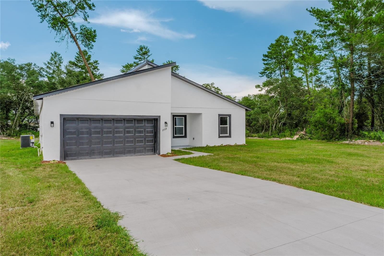 New, modern home built on a spacious 0.53-acre lot, combining comfort, space, and contemporary design. This property offers 4 spacious bedrooms and 3 full bathrooms, including a primary suite with a soaking tub perfect for relaxation. Luxury vinyl flooring runs throughout the home, providing both beauty and easy maintenance. The open-concept kitchen features quartz countertops, modern white cabinetry, and stainless steel appliances, creating a functional and elegant space. The living room boasts high ceilings and abundant natural light, enhancing the sense of openness and warmth. Additional features include a 2-car garage with an automatic door, exterior LED lighting, a convenient laundry area, and a septic system for added independence. The large lot offers privacy and plenty of room for future landscaping or outdoor projects. Ideally located close to shopping, schools, and recreational areas.