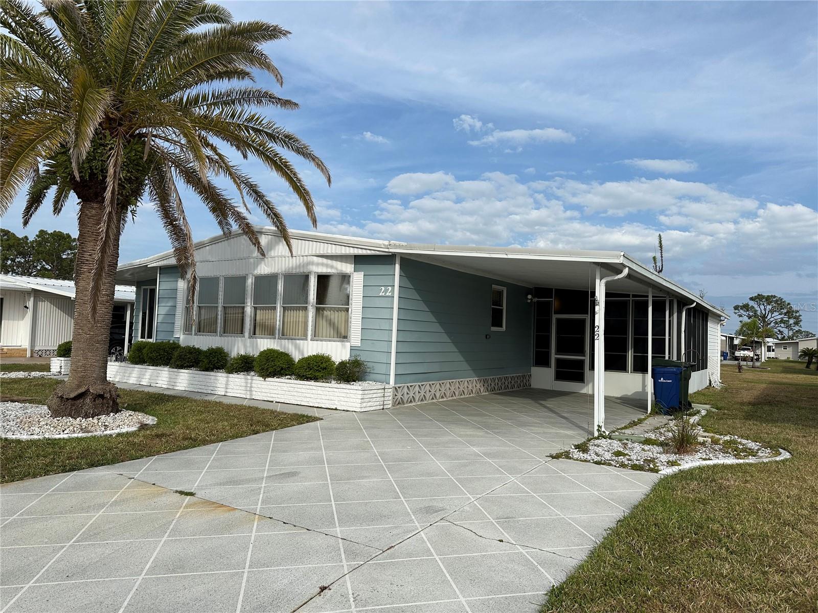 This 2 bedroom, 2 bathroom home is nestled in the highly desirable, land-owned, pet-friendly community of Harbor Isles. This property presents a unique opportunity for those looking to enjoy the Florida lifestyle with room to make it their own. Inside, you'll find a comfortable layout with spacious living and dining areas, plush carpeting, and durable vinyl flooring. The kitchen provides plenty of cabinet space and natural light, making it easy to envision your personal touch throughout. While the home needs some updates and attention, it offers a great foundation to renovate and customize to your taste. The primary suite features generous closet space and a private en-suite bathroom, while the second bedroom and guest bath offer comfort and flexibility for visitors or hobbies. A lovely screened-in porch provides a peaceful space to sip your morning coffee or unwind in the evening breeze. Outside, the covered carport and easy-to-maintain yard provide a great space for relaxing or enjoying the Florida sun. Residents of Harbor Isles enjoy an active community with amenities including a heated pool, fitness center, clubhouse, tennis, pickleball, and boating access to the Myakka River and Gulf. With a monthly condo fee of $190, you’ll appreciate the low-maintenance living and vibrant neighborhood setting. Located just minutes from shopping, dining, and Gulf Coast beaches, 22 Nautical Drive is a great opportunity to create your own coastal retreat in a fantastic community.