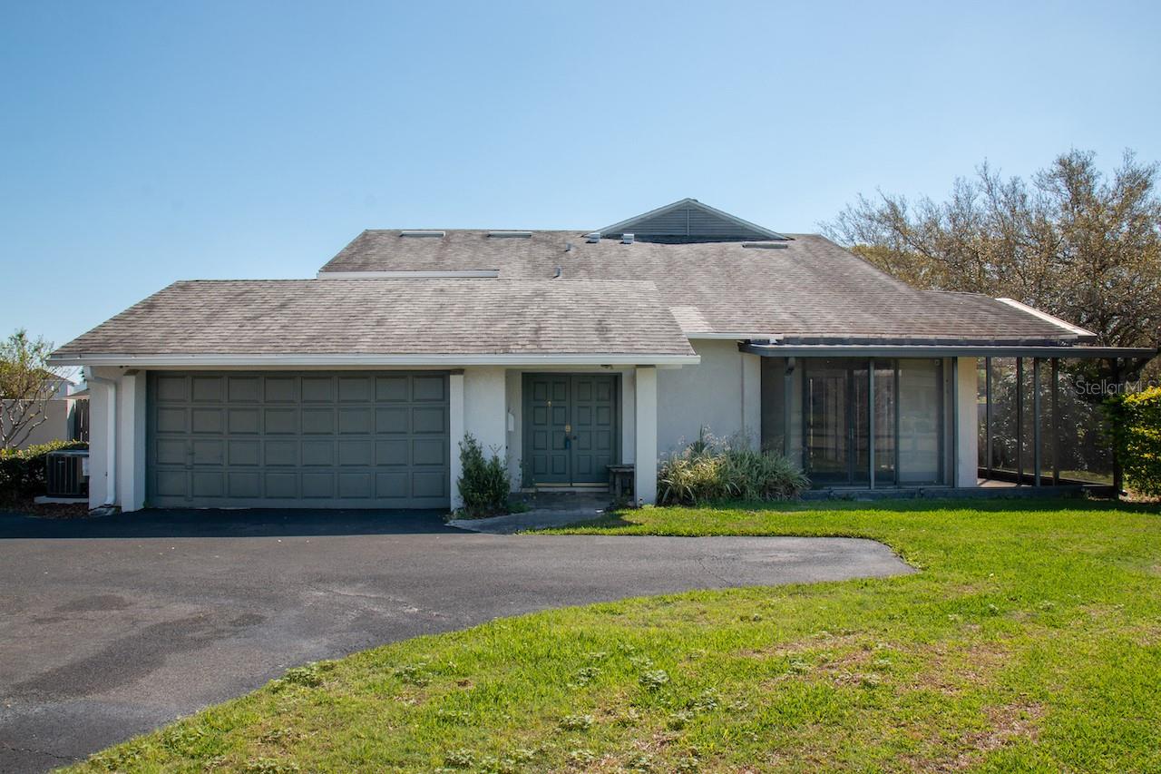 Come see this 2-story condo for sale in a prime location near Universal Studios, and the Dr. Phillips area! This end-unit home has a walkable yard, maintained by the HOA, along with a view of the nearby pond, as well as a long driveway with parking spots situated along the driveway itself. Additionally, this condo comes with a 2-car garage! Entering the home, you will immediately notice the vaulted ceilings which will add to the open feeling of the already-spacious living room. You will also notice windows that wrap around the home, providing ample amounts of natural light. The open kitchen adds character to this downstairs space with its corian countertops and standalone island/eating space. Immediately outside the kitchen and living room is a wraparound screened porch, ideal for relaxing and entertainment. The A/C is only 2 years old, and the roof and exterior are maintained by the condo association. Water, sewer, and cable are included in the condo fees, as well as grounds maintenance.