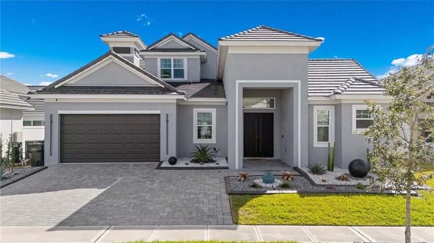 Located in the gated golf community of Providence, this stunning semi-custom 4-bedroom, 3 full bathroom, and 2 half bathroom home is truly a must-see.

From the moment you arrive, you'll notice the upgraded landscaping and beautiful water feature, creating a welcoming first impression. As you open the front doors, you're greeted by a private courtyard with a heated pool and built-in spa, offering a peaceful and secluded outdoor living space.

To the left of the courtyard is a private office with a half bath, sliding patio doors, and direct access to the garage. This thoughtfully designed home also features a separate in-law suite with its own full bathroom, large vanity, and walk-in shower with glass doors, along with sliding doors overlooking the pool area. Double doors connect the suite to the main home, providing both privacy and convenience.

Inside the main living space, the home showcases an ultra-modern design with high ceilings, upgraded baseboards, wood-look tile flooring throughout, and no carpet anywhere in the home. The open floor plan includes a stylish living area with a built-in fireplace and fantastic golf course views.

The upgraded kitchen features sleek black cabinetry, white quartz countertops, a Samsung cooker hood, flat-top stove, closet pantry, and glass cabinet doors, creating a contemporary and functional cooking space.

The spacious primary suite offers sliding glass doors leading to the pool area and a luxurious spa-like bathroom complete with a soaking tub, walk-in shower, dual sinks, and a charming barn-style door.

Upstairs in the main home, you'll find two generously sized bedrooms that share a well-appointed bathroom.

Residents of Providence enjoy exceptional resort-style amenities, including an 18-hole golf course, lap pool, resort-style pool with waterslide, fitness center, restaurant and bar, tennis and pickleball courts, and two dog parks.
Conveniently located near ChampionsGate, I-4, Disney, Celebration, and many of Central Florida's top attractions, this home offers the perfect blend of luxury, privacy, and convenience.

Schedule your private showing today.