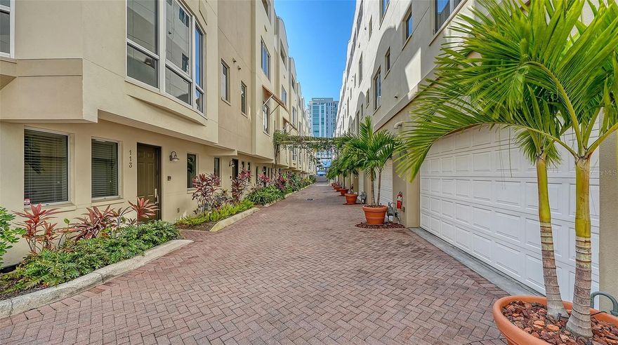 Live where Sarasota comes alive. Located just moments from Florida Studio Theater and downtown Sarasota's Main Street dining, shopping, and cultural attractions, this three-bedroom, four-and-a-half-bath luxury end unit townhouse offers the perfect blend of sophistication, comfort, and walk-everywhere convenience. This four-story residence is truly one of a kind with a private elevator, two-car garage, and nearly 2,400 square feet of thoughtfully designed living space. From the moment you enter, the home feels welcoming and effortless. The first level features the garage with lots of overhead storage, a gym with a full bathroom and storage space, and a gracious foyer that sets the tone for what’s ahead. Take the elevator or the beautifully crafted wood staircase up to the main living level, where an open gourmet kitchen anchors the space. It's complete with granite countertops, natural gas stovetop, stainless-steel appliances, breakfast bar, a half bath, formal dining area, and an inviting family room ideal for both quiet evenings and entertaining. The third floor is the private bedroom level offers a serene primary suite and a second bedroom, each with walk-in closets and ensuite baths—perfectly designed for comfort and privacy. The top floor is a true standout: a flexible bonus space or guest suite with kitchenette and access to outdoor space ideal for grilling, relaxing, or tending plants. Tucked within a gated community featuring a heated pool, spa, and fitness center, this residence offers easy, carefree living in the heart of Sarasota. Schedule your private showing and see how seamlessly downtown living can fit your lifestyle.