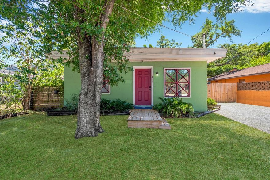 Welcome home! Charming 3-bedroom, 1-bath home with a fully fenced backyard, ideally located in southeast Seminole Heights and ready for its next owner. This light-filled home features laminate and tile flooring throughout (no carpet!) along with abundant windows that make it bright and cheerful. Stylish vintage-inspired light fixtures accent the dining, living, and primary bedroom spaces. The kitchen offers open shelving, perfect for displaying dishware, and includes convenient in-kitchen laundry hookups. A cozy little dining nook is nestled in the living room corner for casual meals while watching TV.  All three bedrooms are generously sized and have closets, ceiling fans, and overhead lighting. Crowne molding throughout elevates the spaces. Step outside to a spacious backyard with endless potential — ideal for gardening, pets, entertaining, or creating a private retreat. Rock climbing wall included. Conveniently located with easy access to I-275, downtown Tampa, Tampa International Airport, and University of Tampa. Welcome home!